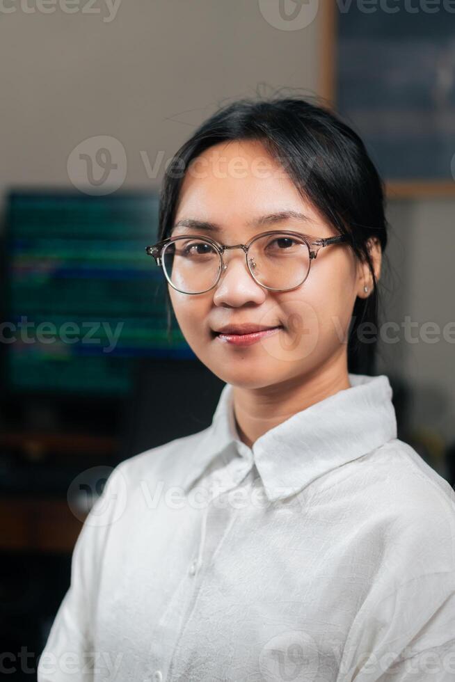 A young woman wearing glasses and a white shirt photo