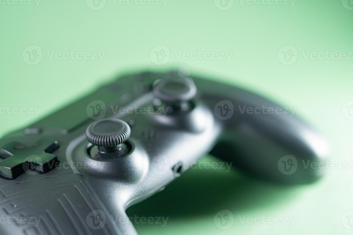 Close-Up of Black Gaming Controller on Green Background photo