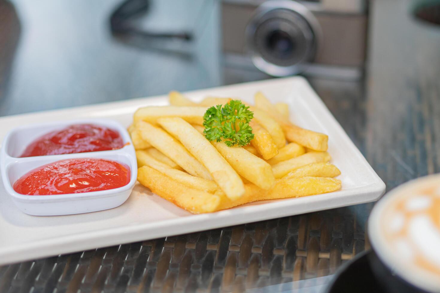 A plate of french fries and ketchup on a table photo