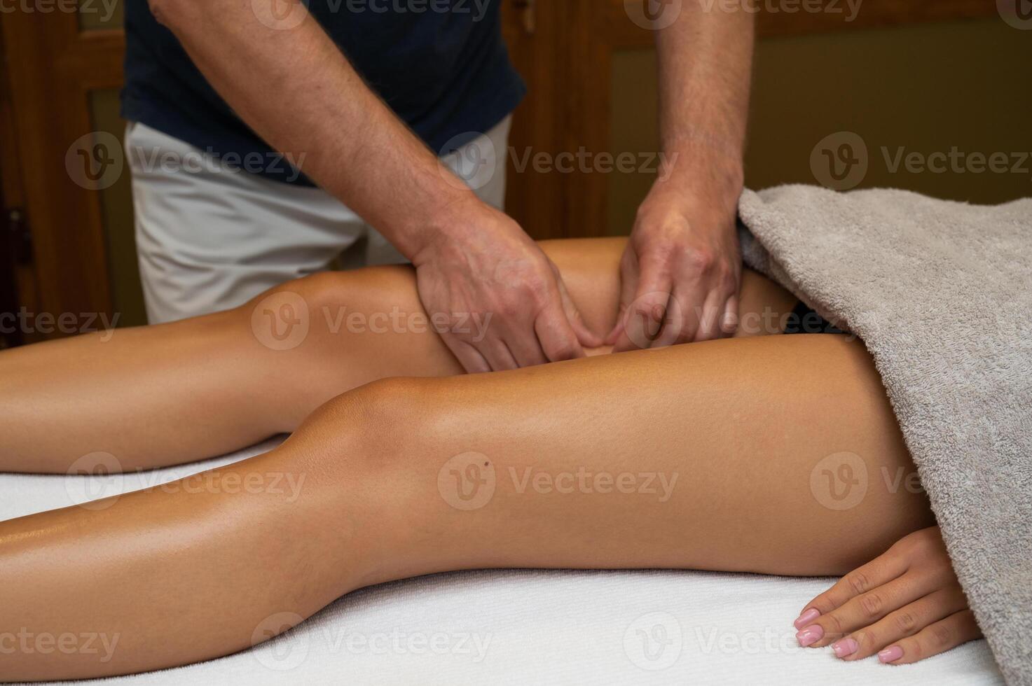 Woman getting legs massage in spa salon photo