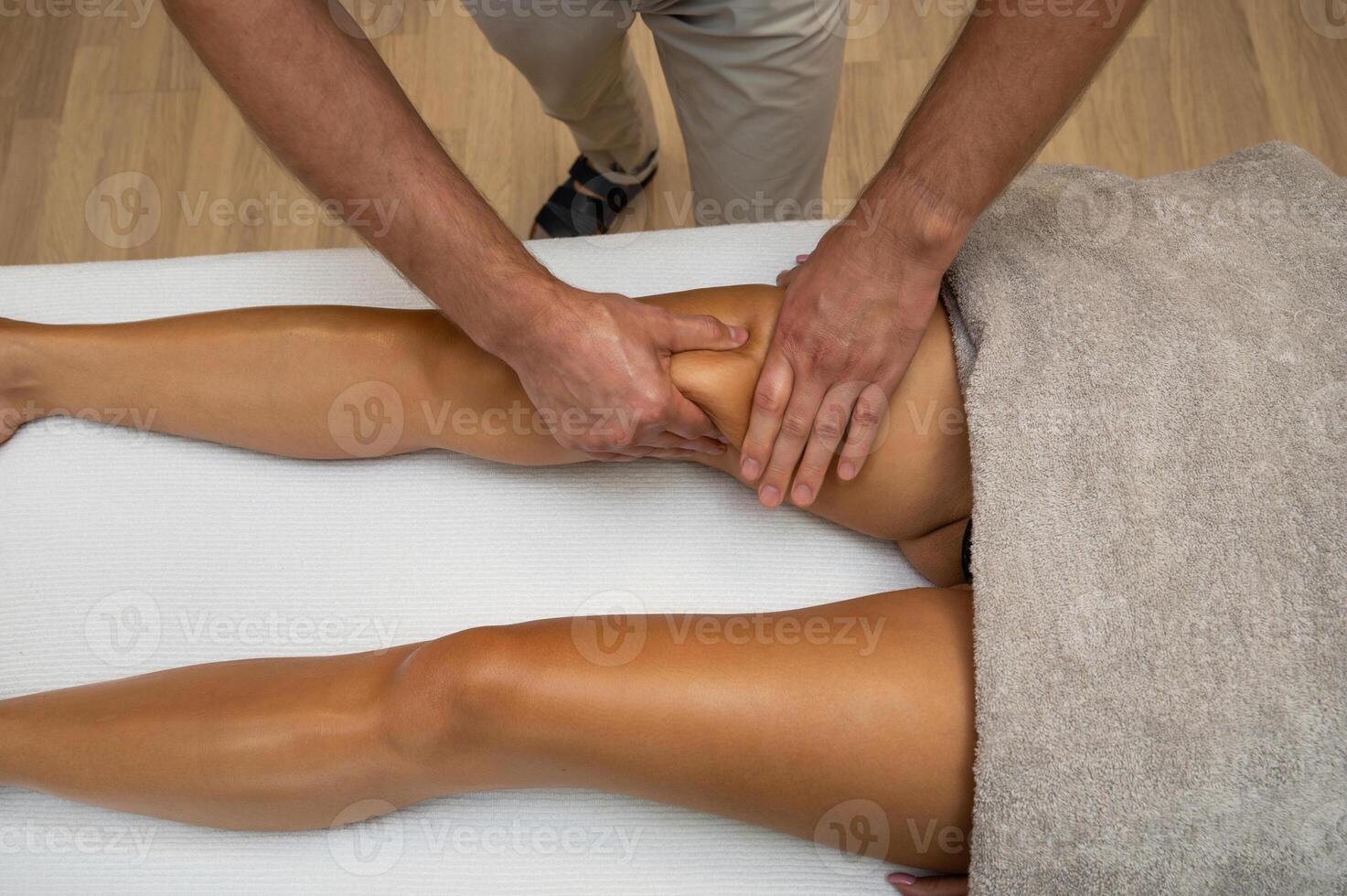 Woman getting legs massage in spa salon photo