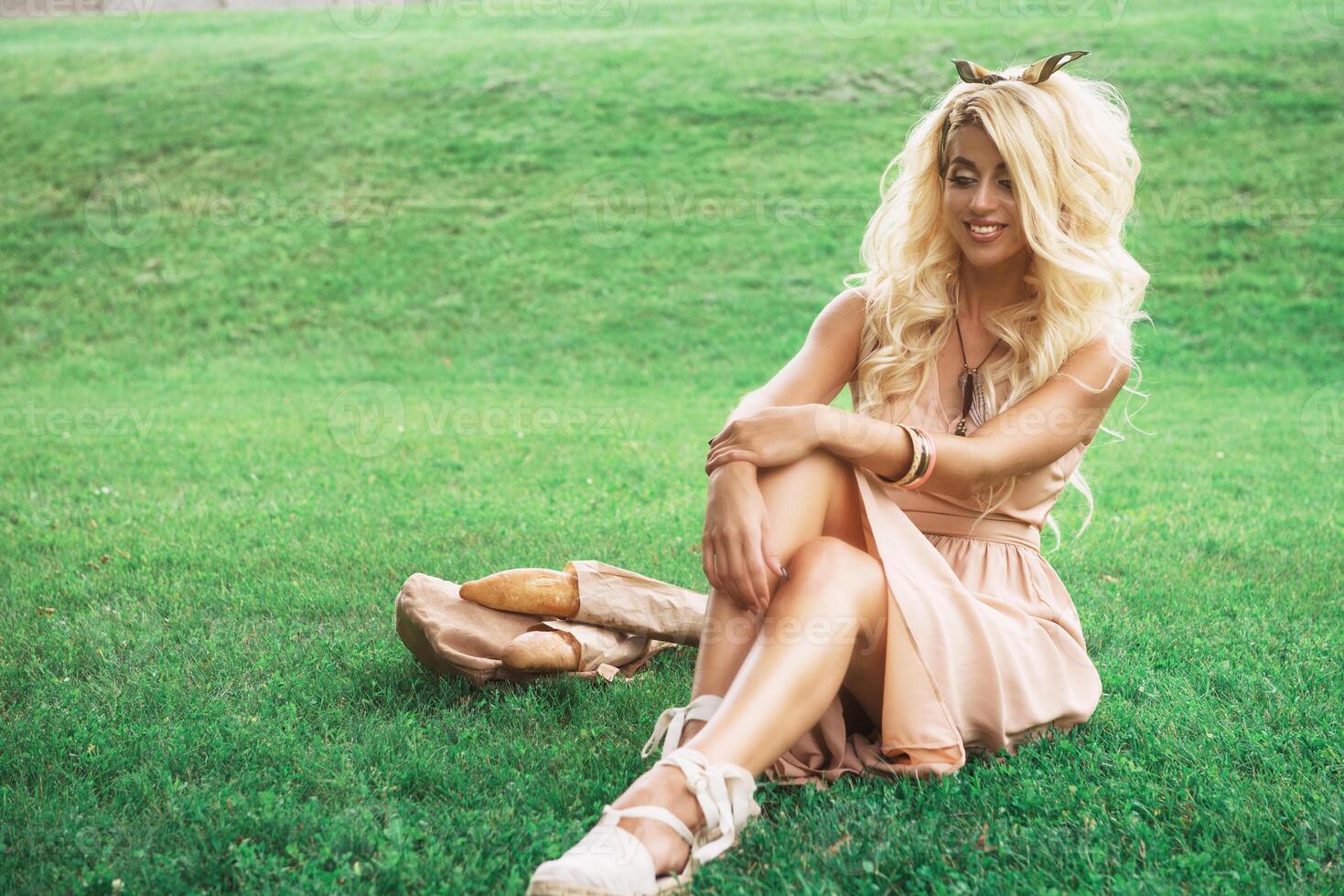 Beauty blonde young woman resting in the park photo