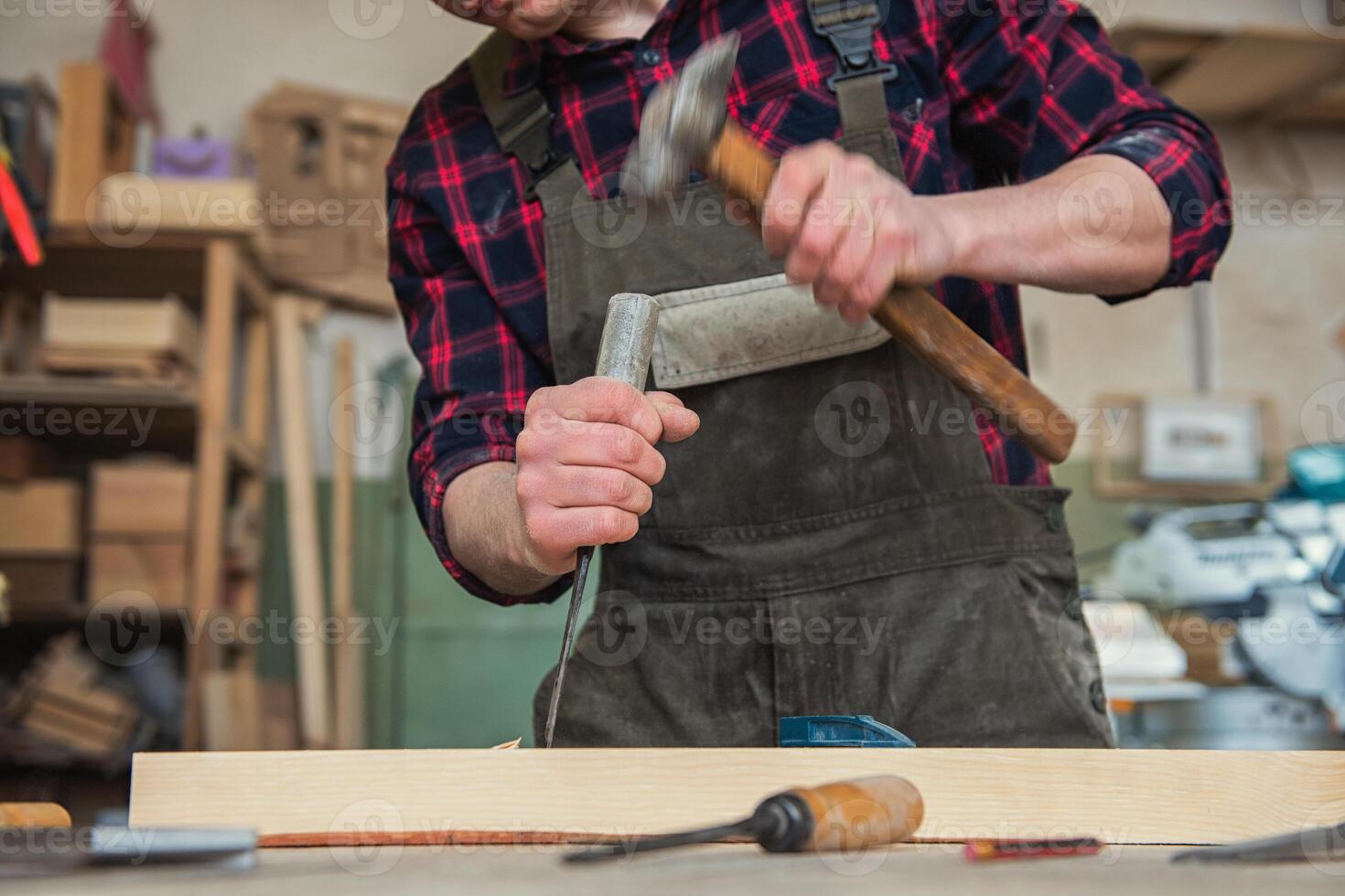Carpenter working with a chisel photo