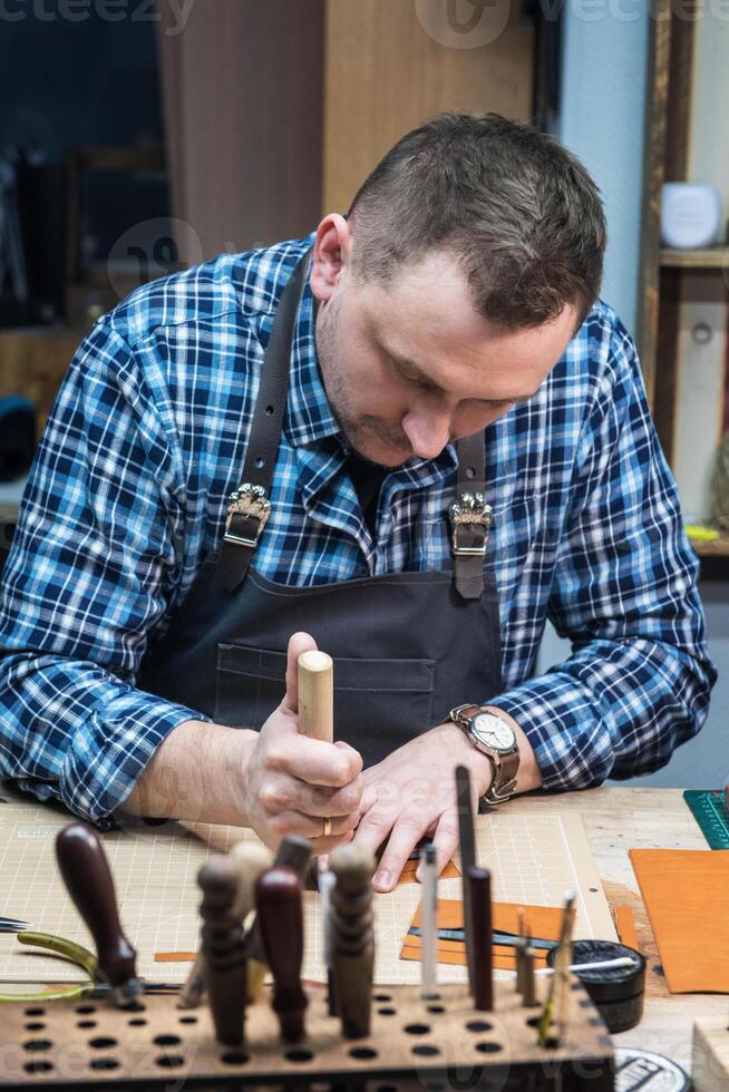 Concept of handmade craft production of leather goods. photo