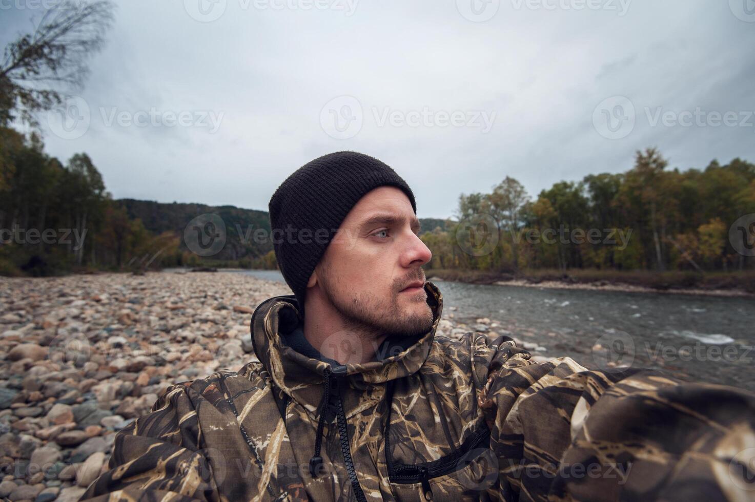 Caucasian man in the mountain making selfie photo