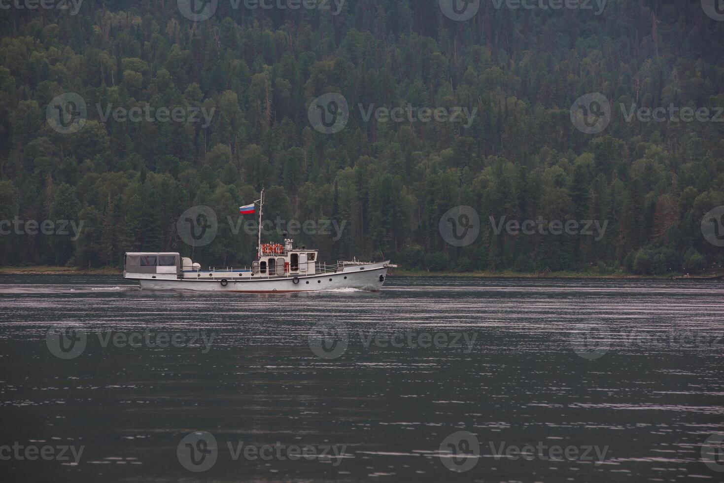 Ship with russian flag on the Teletskoye lake in Altai mountains photo