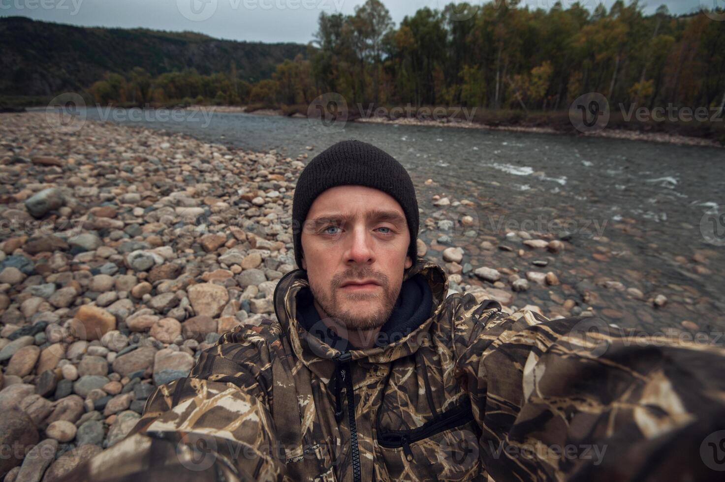 Caucasian man in the mountain making selfie photo