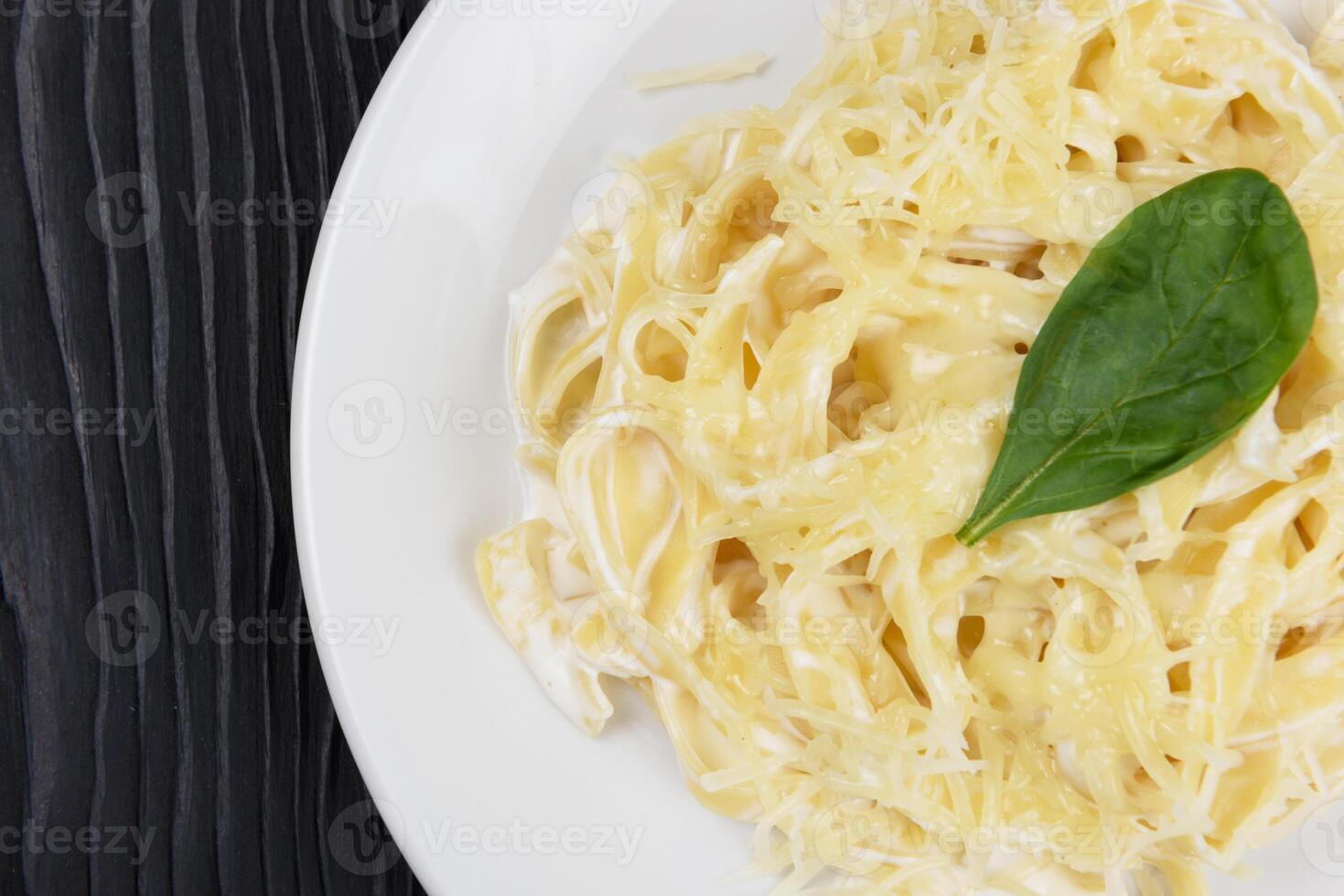 Pasta with sauce and basil photo