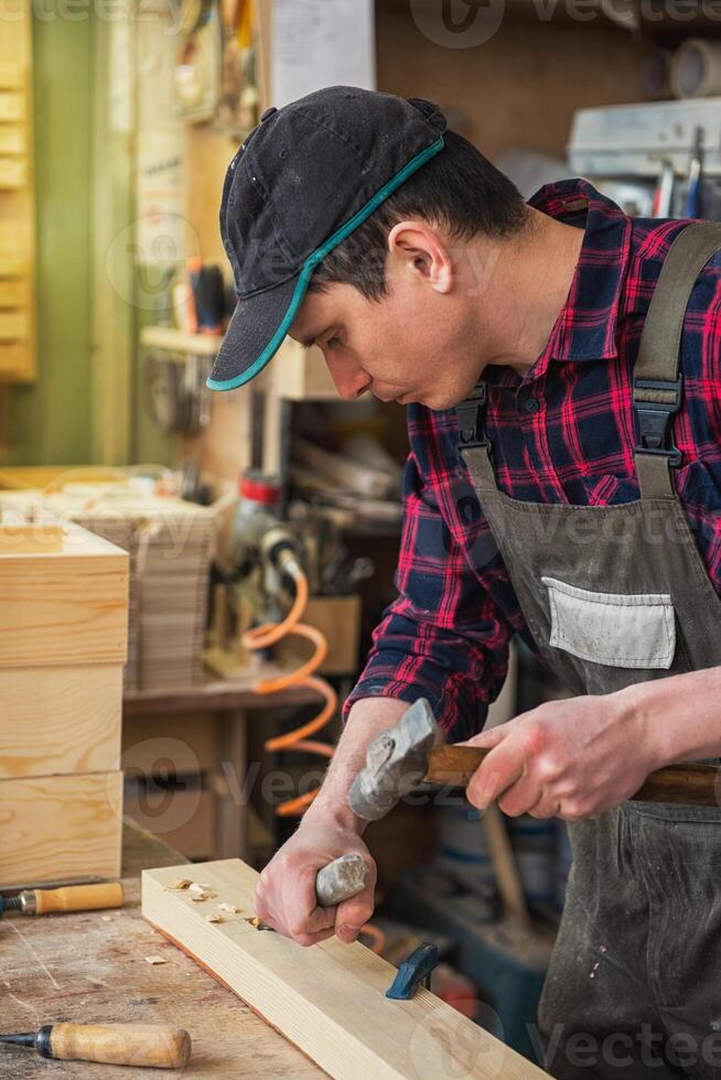Carpenter working with a chisel photo