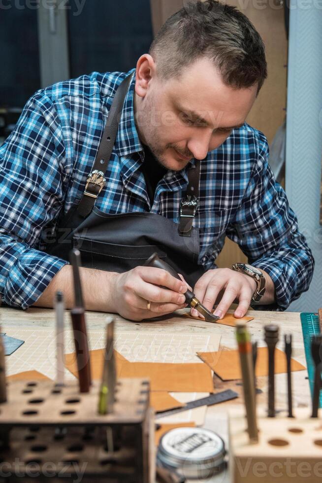 Concept of handmade craft production of leather goods. photo