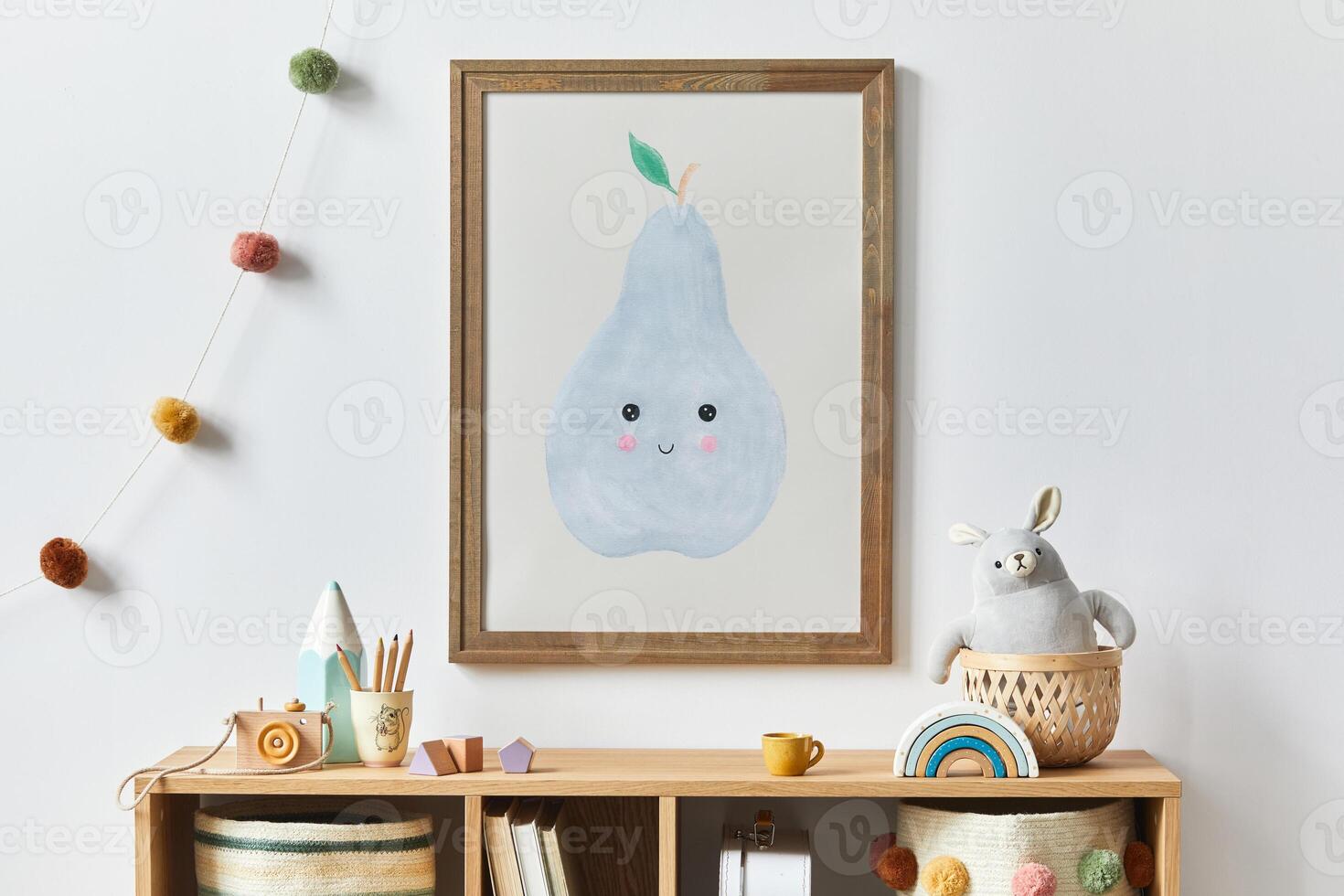 Stylish scandinavian newborn baby room with brown wooden mock up poster frame, toys, plush animal and child accessories. Cozy decoration and hanging cotton flags on the white wall. Template. photo