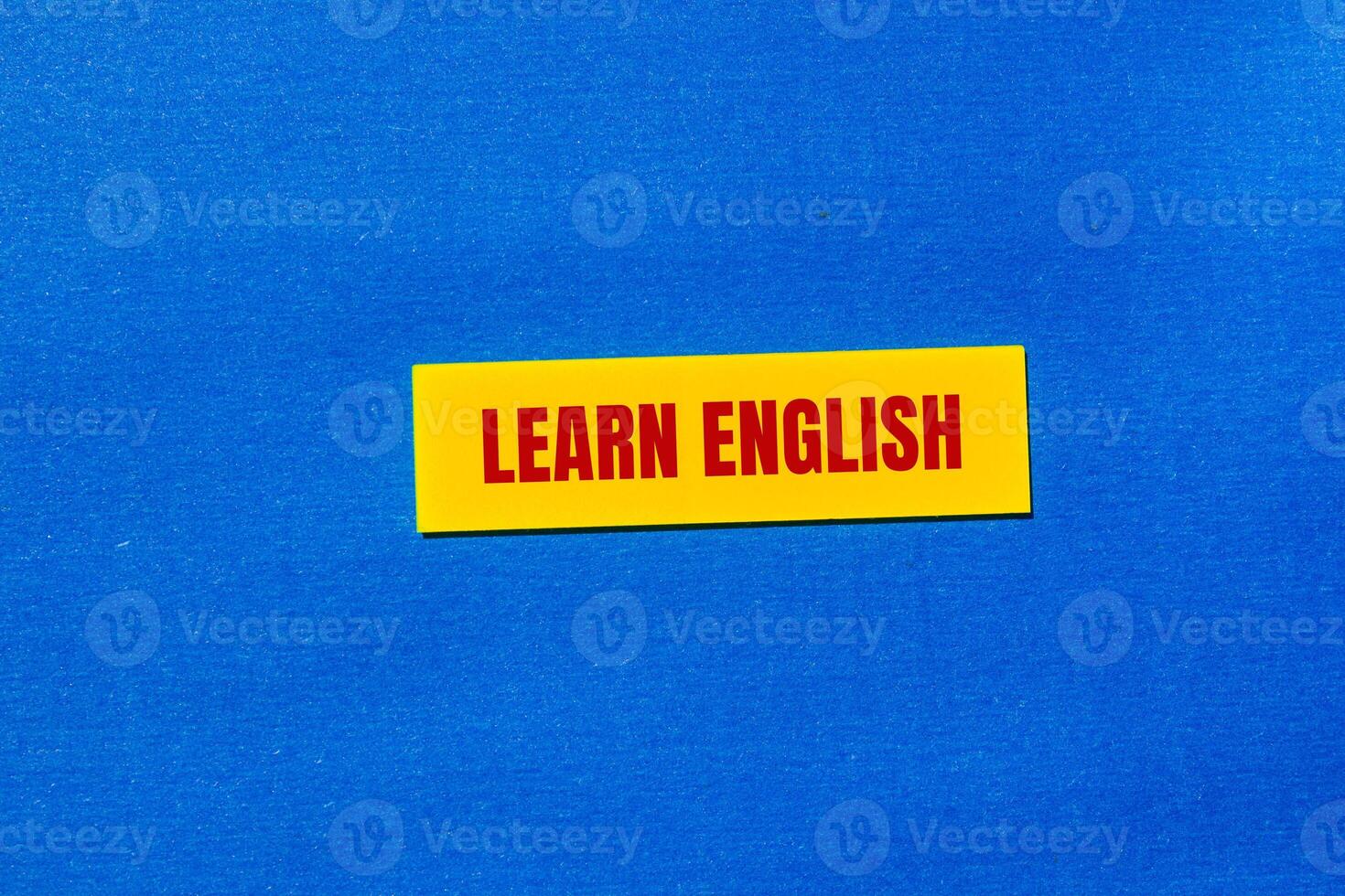 A yellow sticker with a red lettering photo