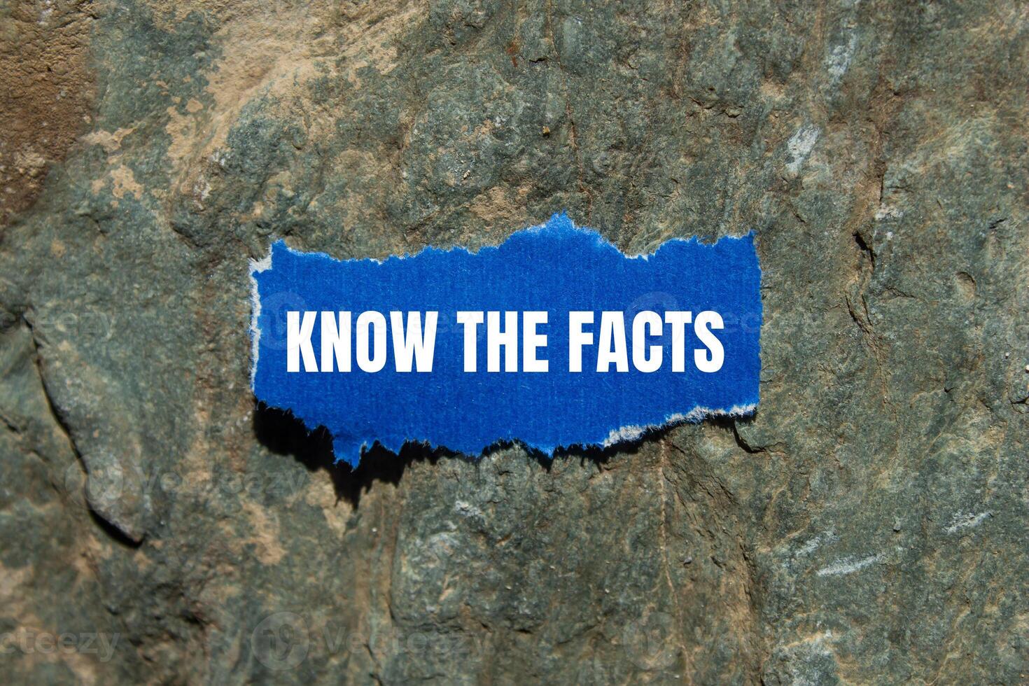 Know the facts message written on ripped torn blue paper piece with stone background. Conceptual know the facts symbol. Copy space. photo