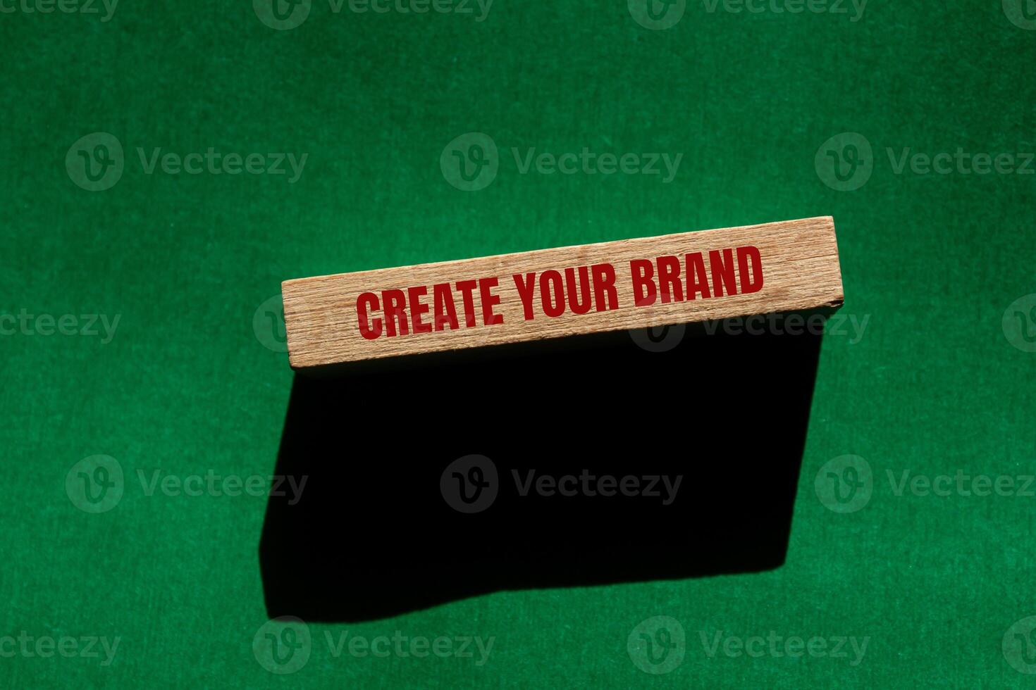 Create your brand message written on wooden block with green background. Conceptual create your brand symbol. Copy space. photo