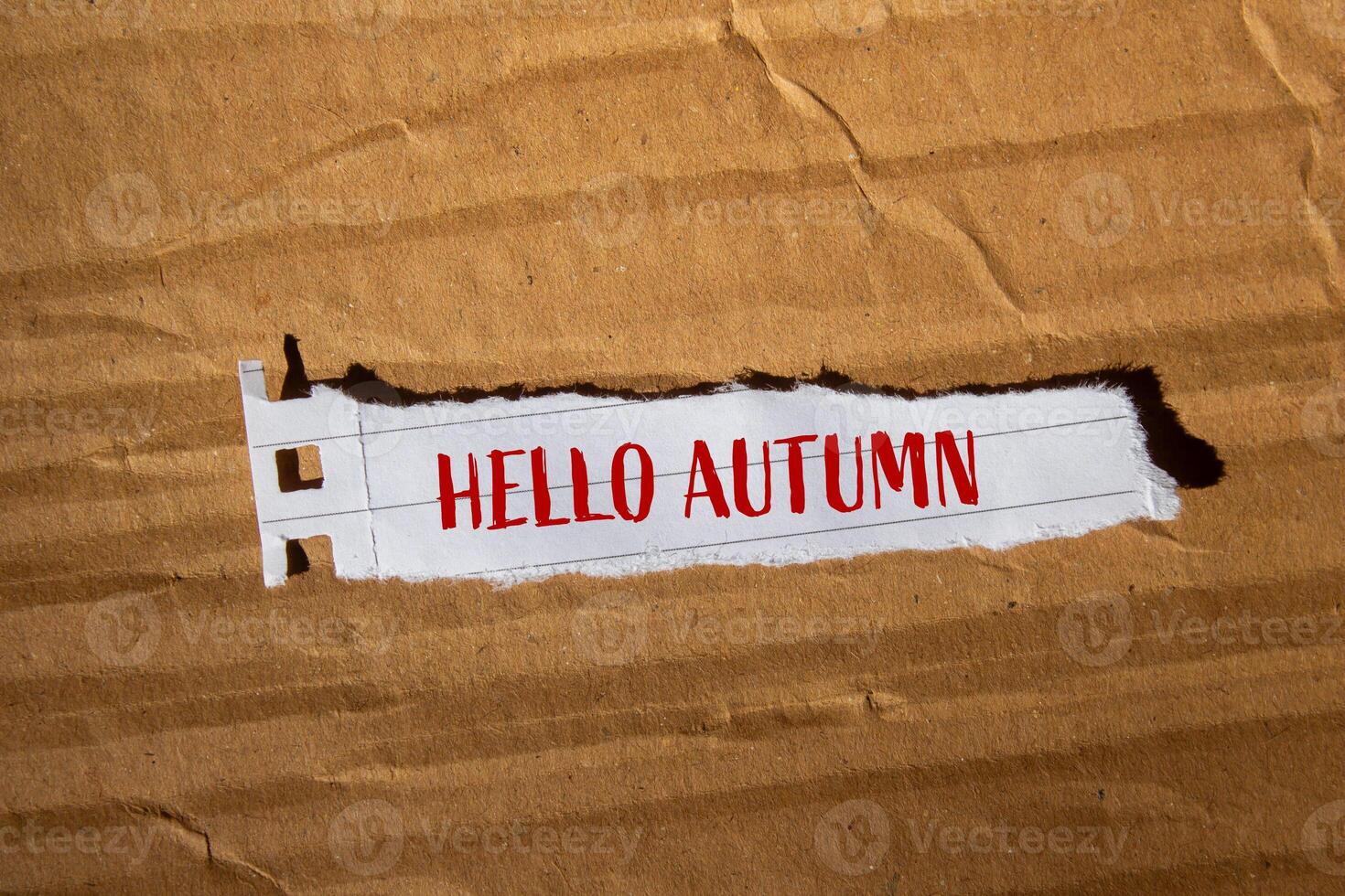 Hello autumn text on torn paper photo