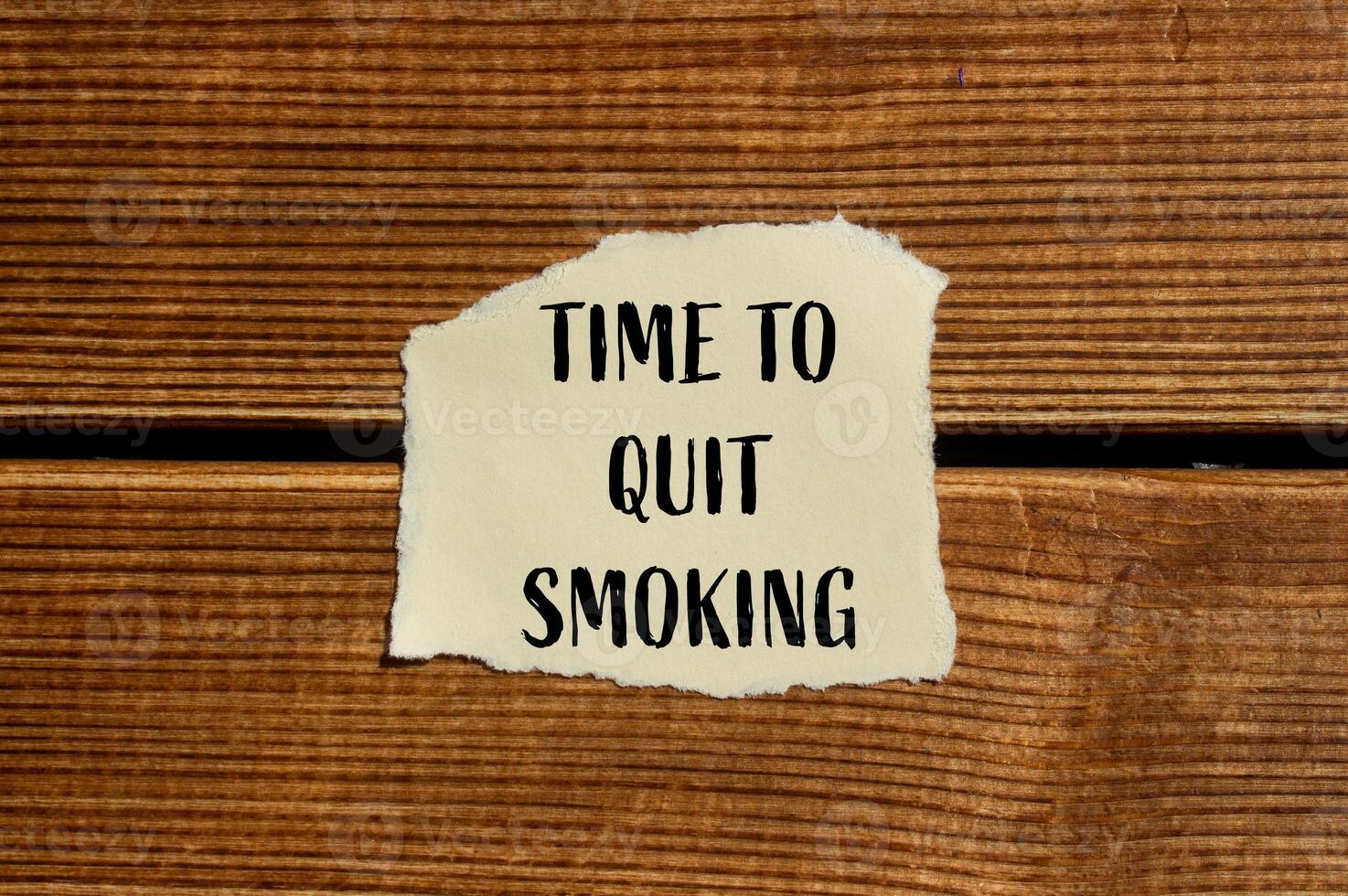 Time to quit smoking text on a piece of paper on a wooden background photo
