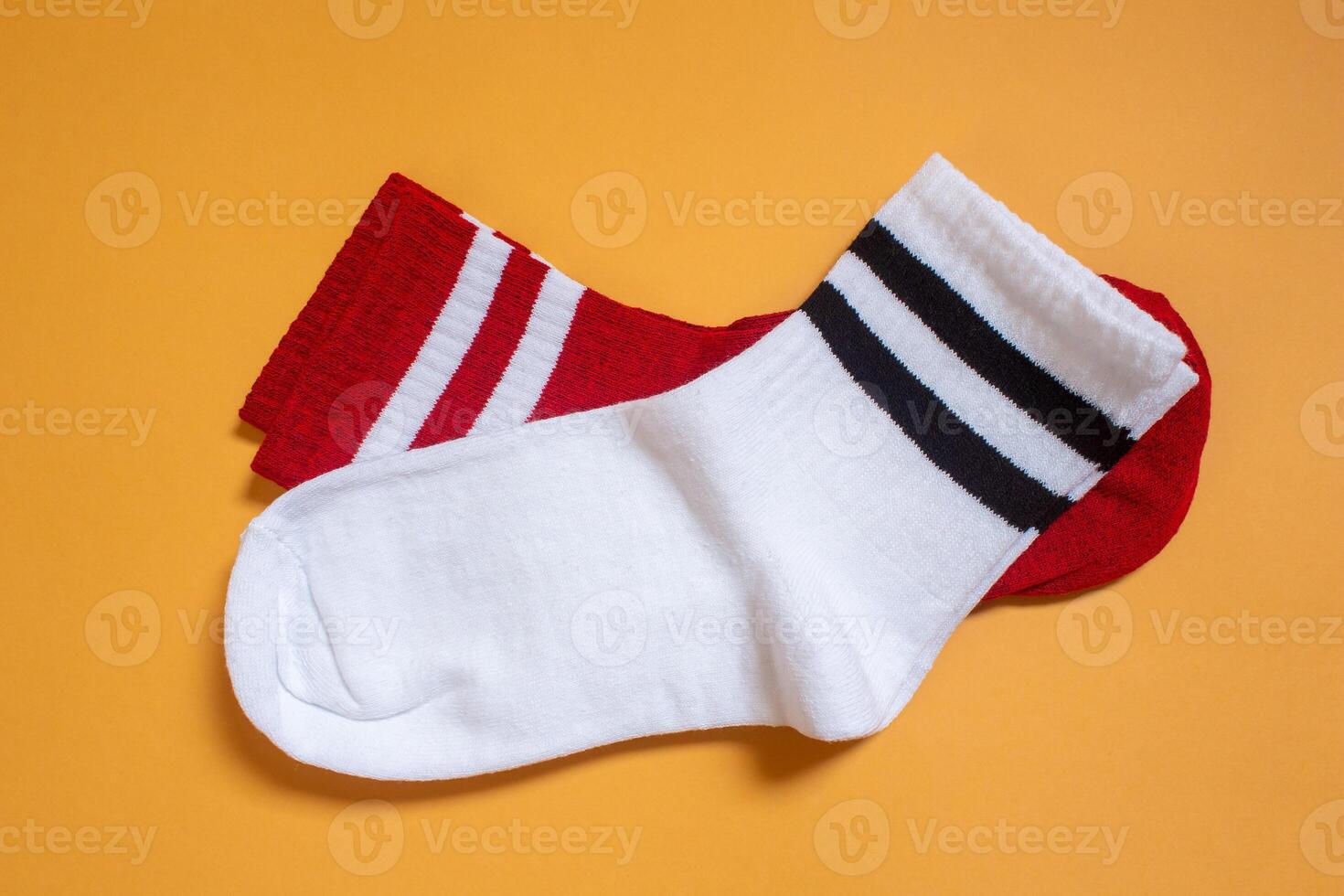 Two pairs of socks on a yellow background photo