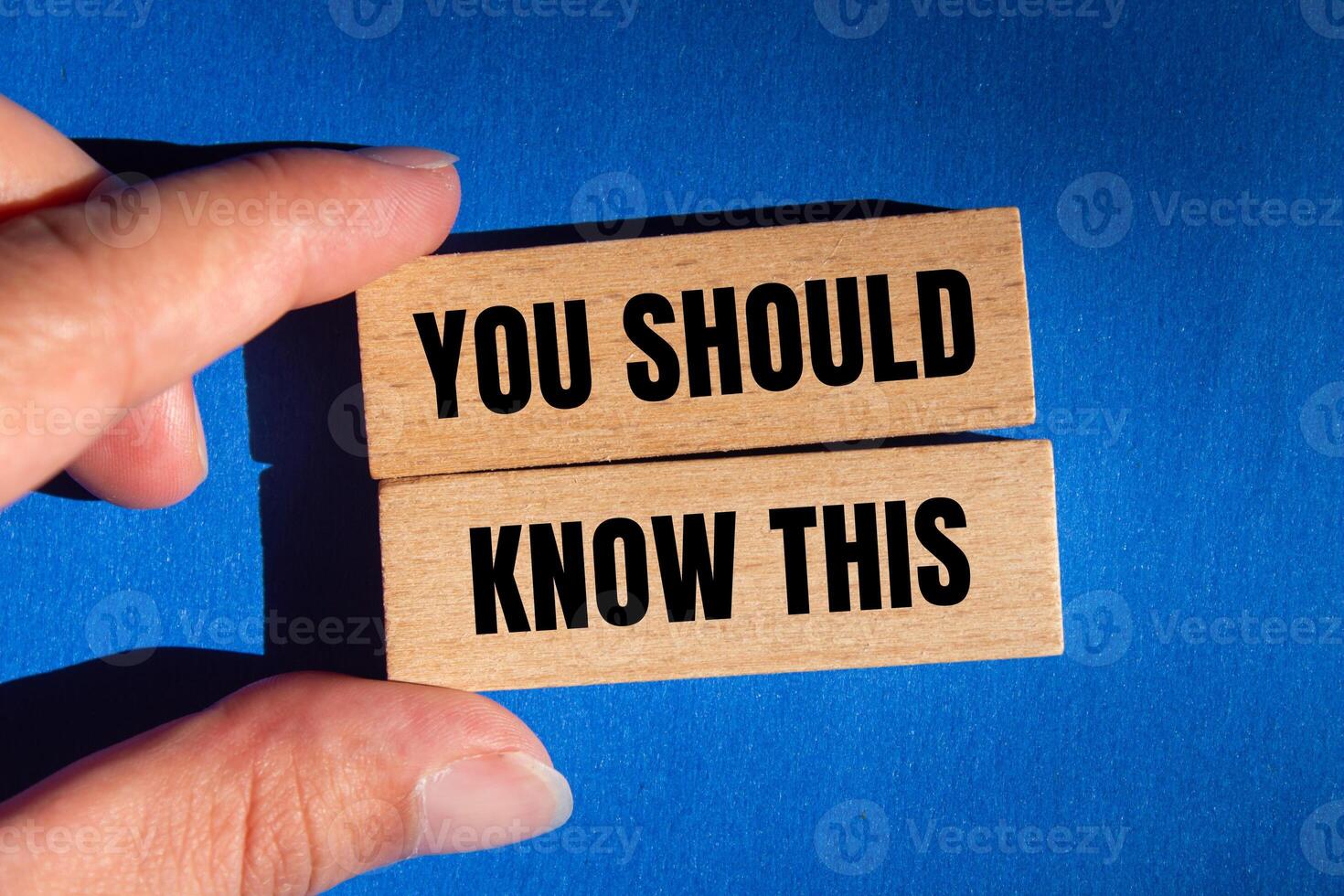 You should know this message written on wooden blocks with blue background. Conceptual you should know this symbol. Copy space. photo