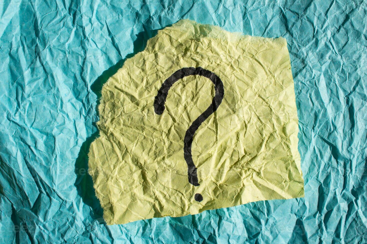 Question mark on crumpled paper stock photo