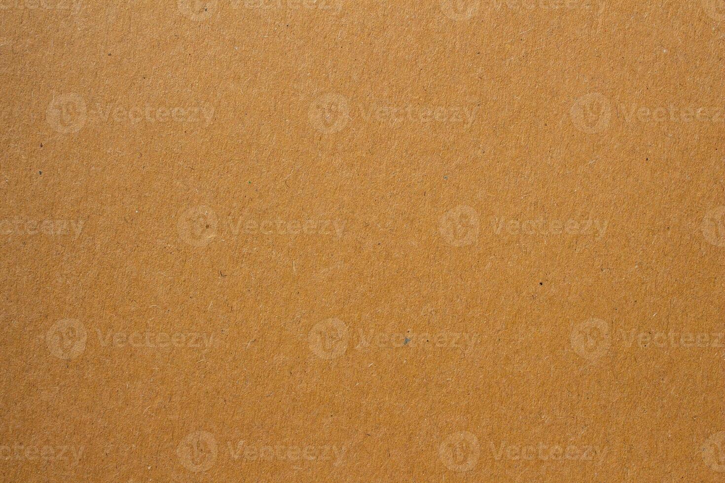 A brown paper texture background with a few small holes photo