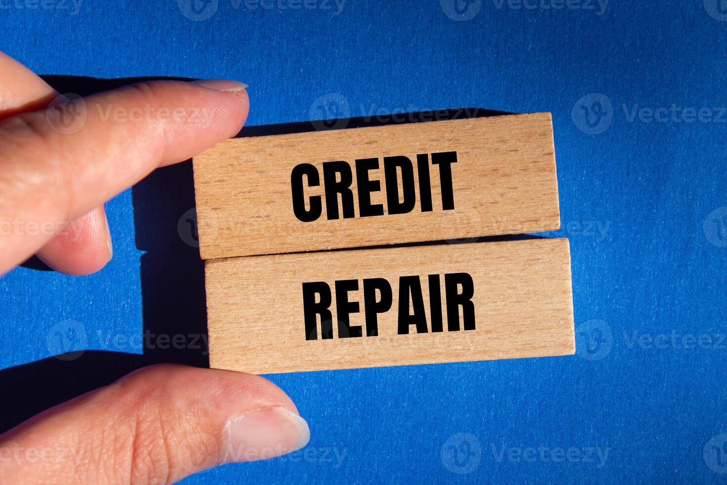 Credit repair message written on wooden blocks with blue background. Conceptual credit repair symbol. Copy space. photo