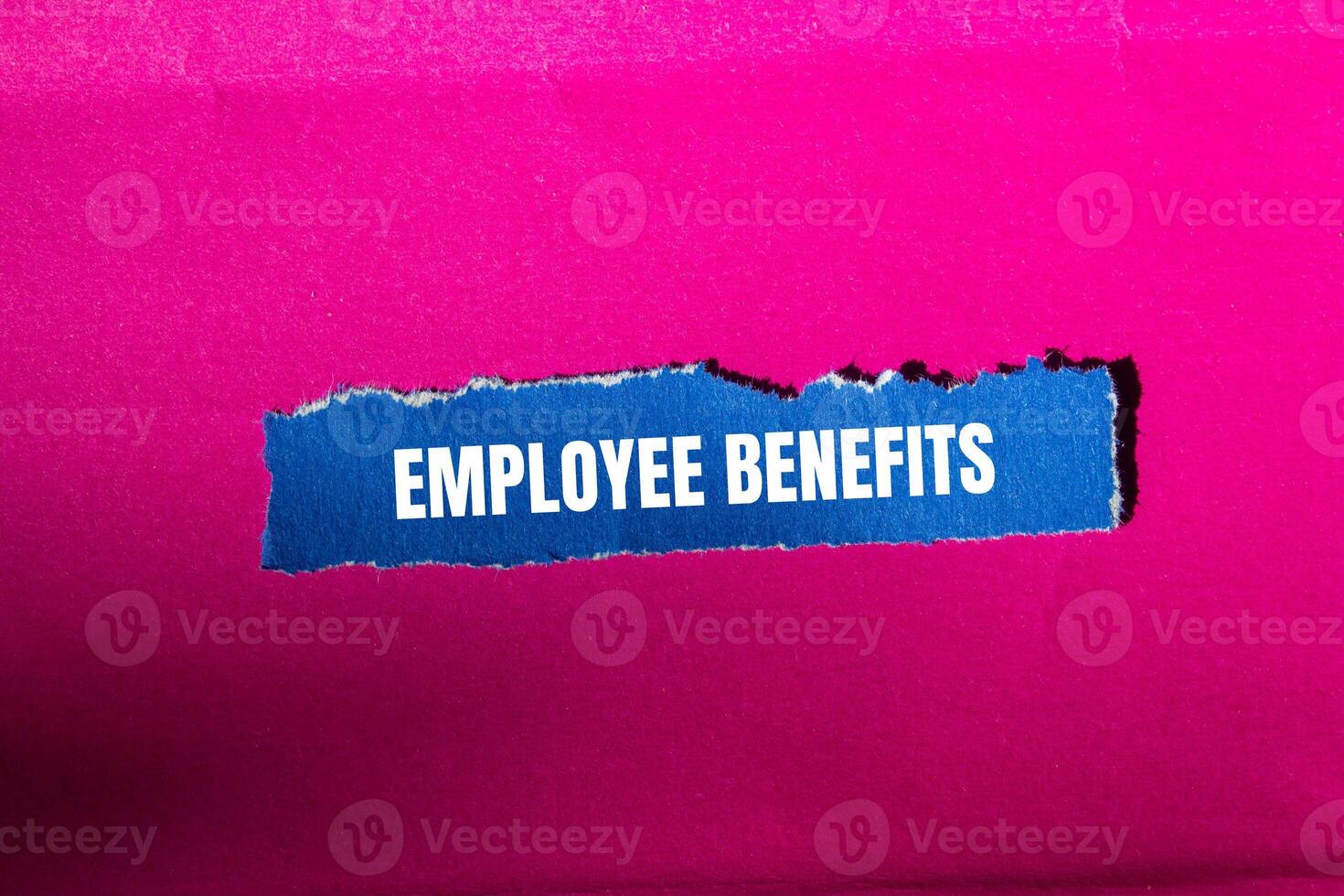 Employee benefits message written on ripped torn blue paper with pink background. Conceptual employee benefits symbol. Copy space. photo
