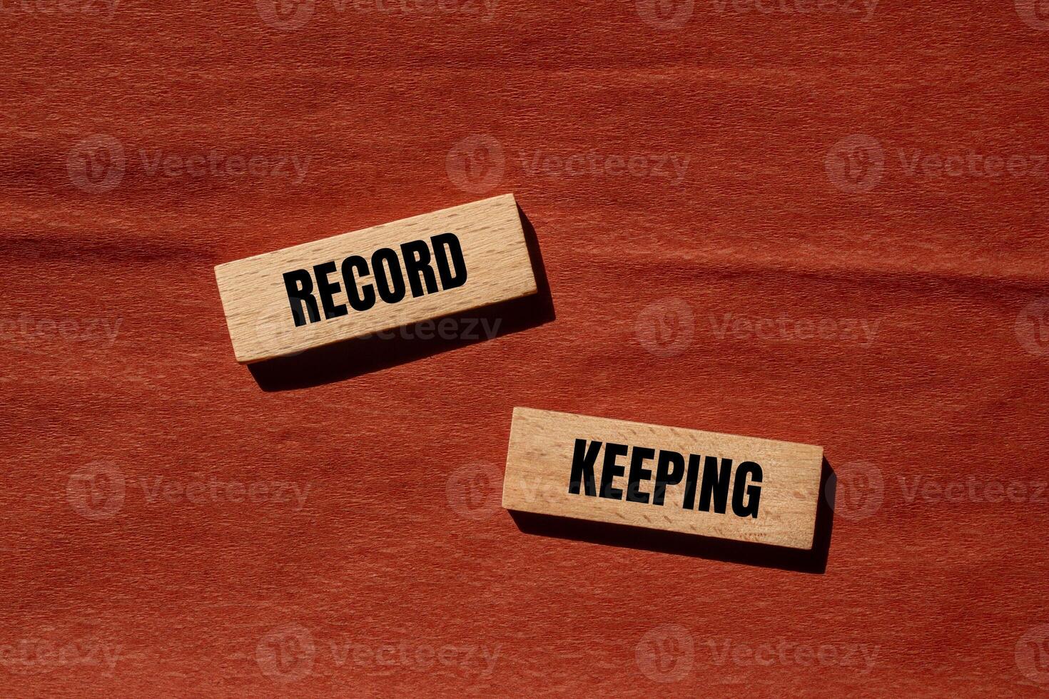 Record keeping message written on wooden blocks with brown background. Conceptual record keeping symbol. Copy space. photo