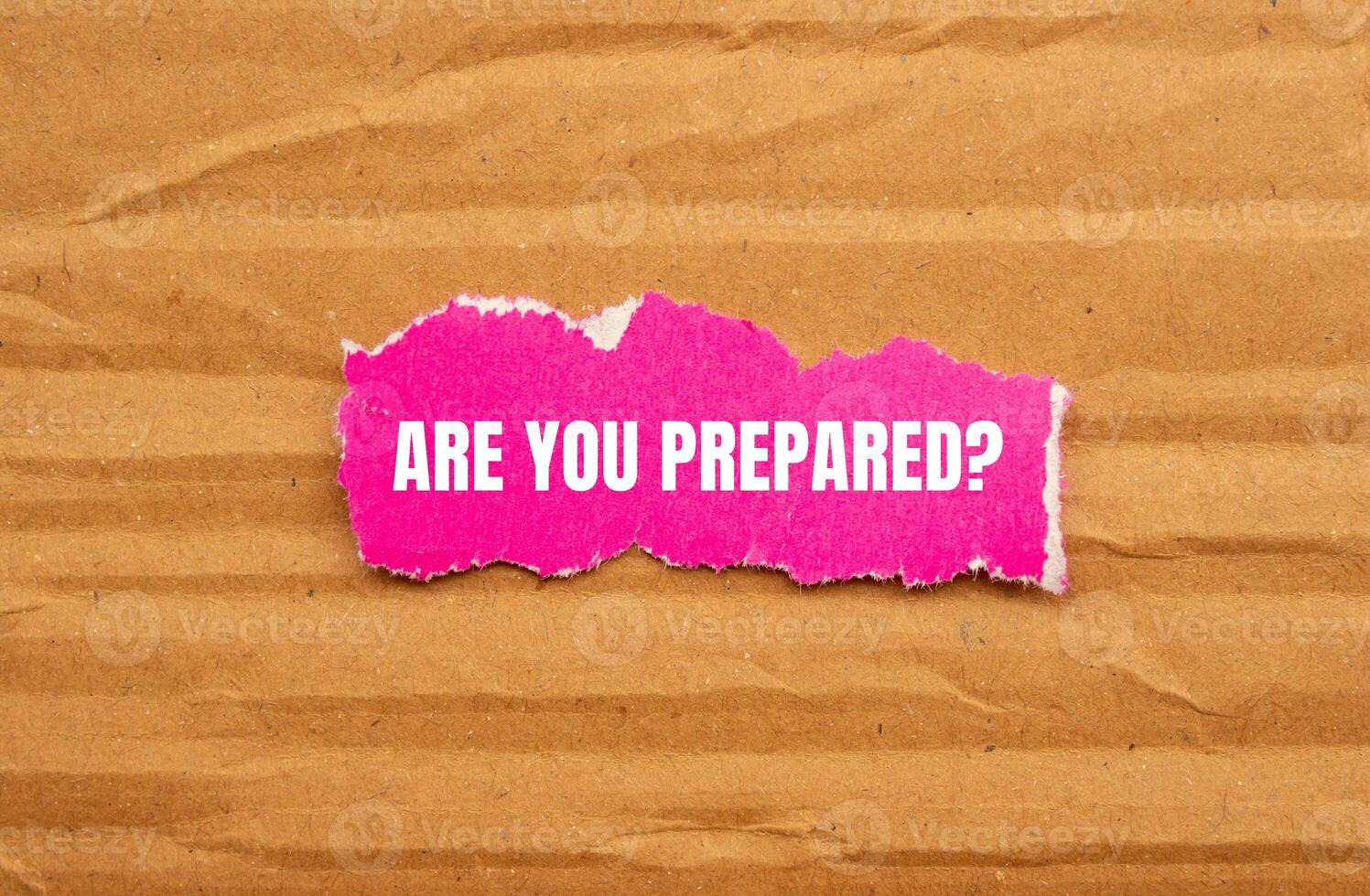 Are you prepared question written on ripped pink torn paper piece with cardboard background. Conceptual are you prepared question symbol. Copy space. photo