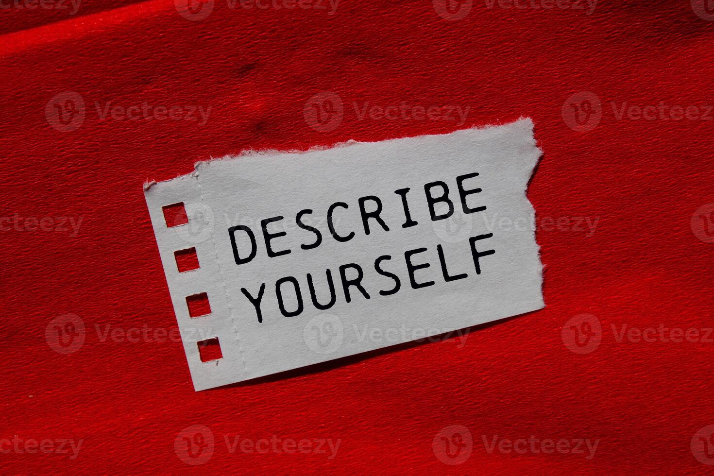 Describe yourself message written on ripped torn paper piece on red background. Conceptual describe yourself symbol. Copy space. photo