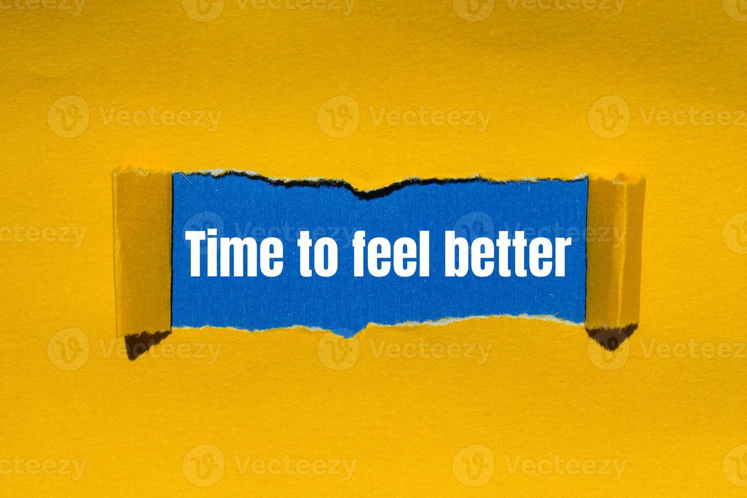 Time to feel better message written on ripped torn yellow paper with blue background. Conceptual time to feel better symbol. Copy space. photo