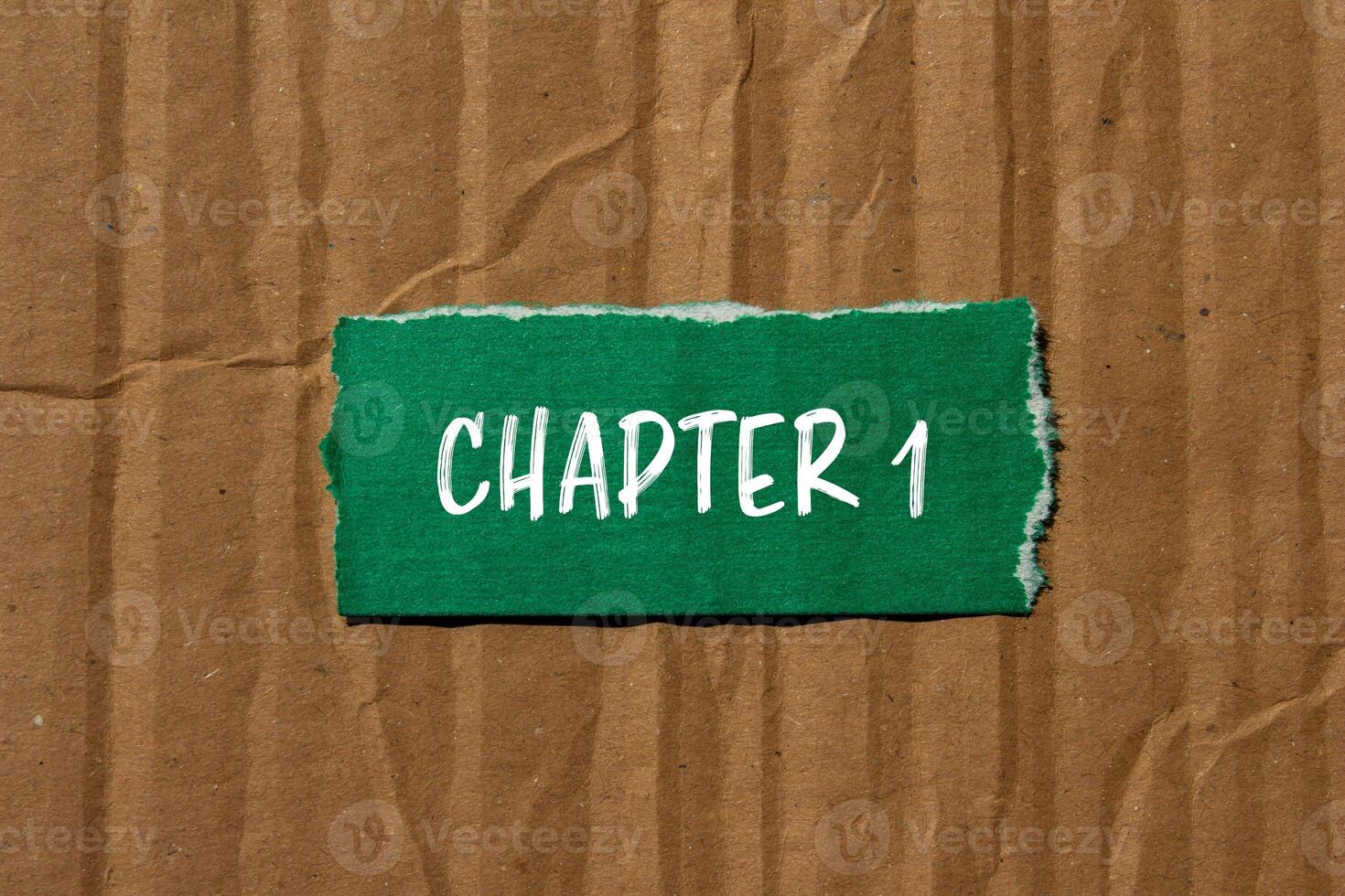 Green paper with the word chapter 1 written on it photo