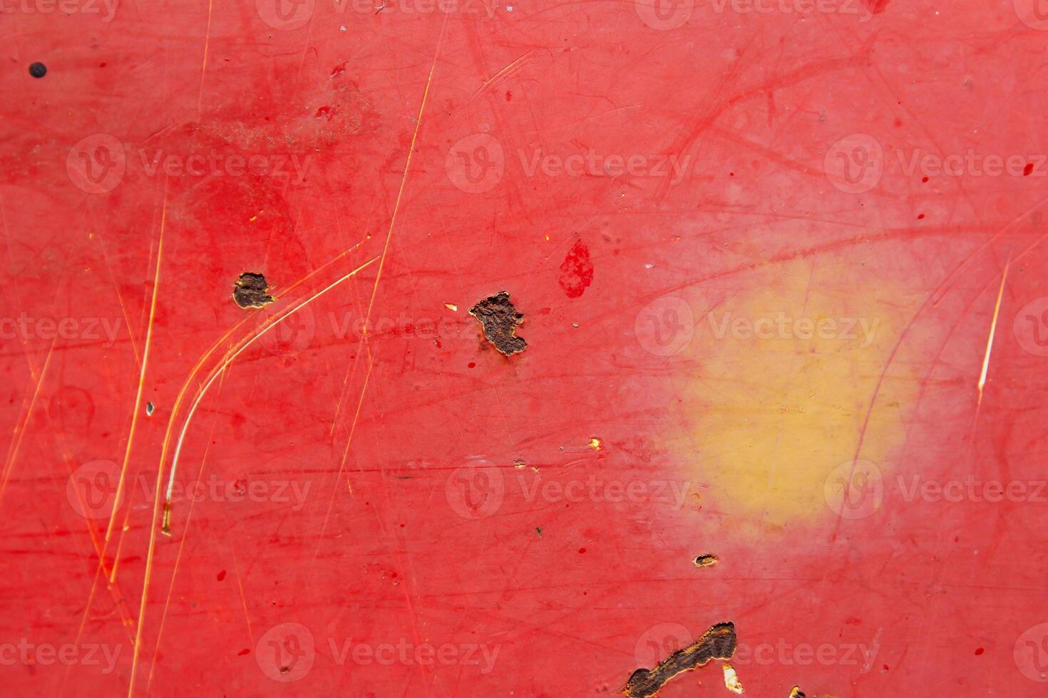 A red surface with a yellow object on it photo