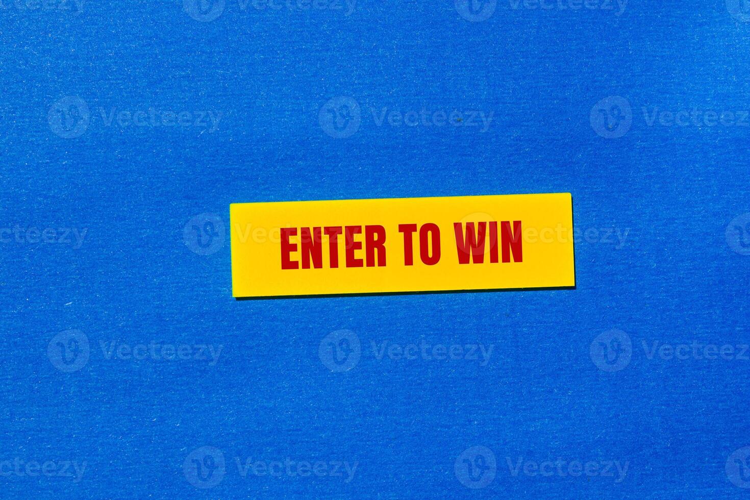 A yellow sticker with the word enter to win photo