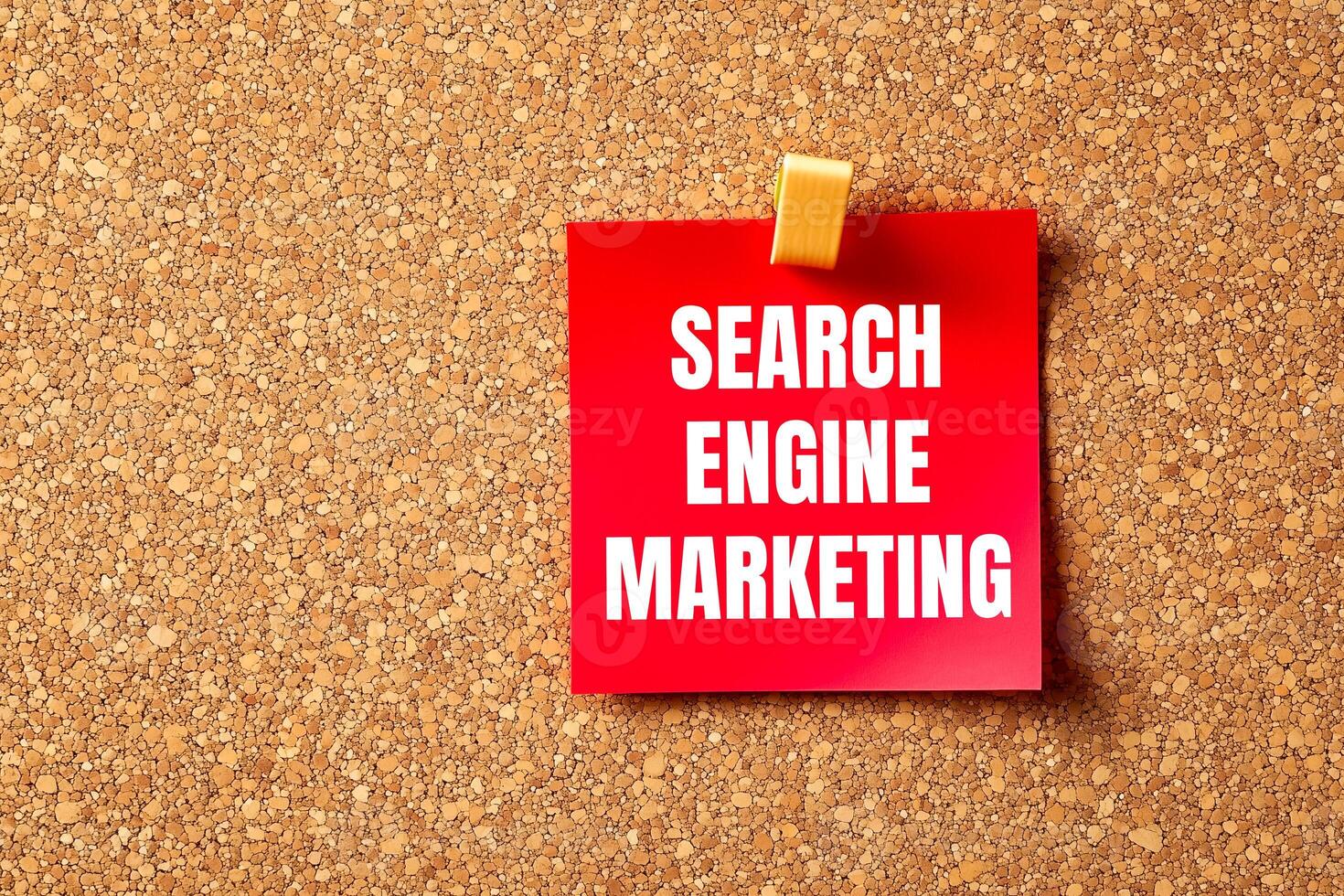 Search engine marketing message written on red paper with brown background. Conceptual search engine marketing symbol. Copy space. photo