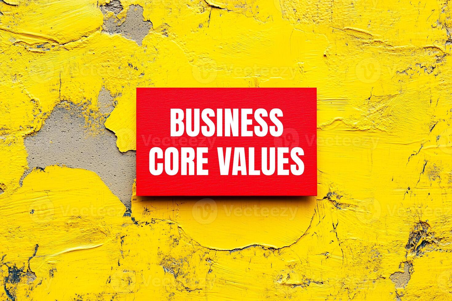 A red sign on a yellow wall that says business core values photo