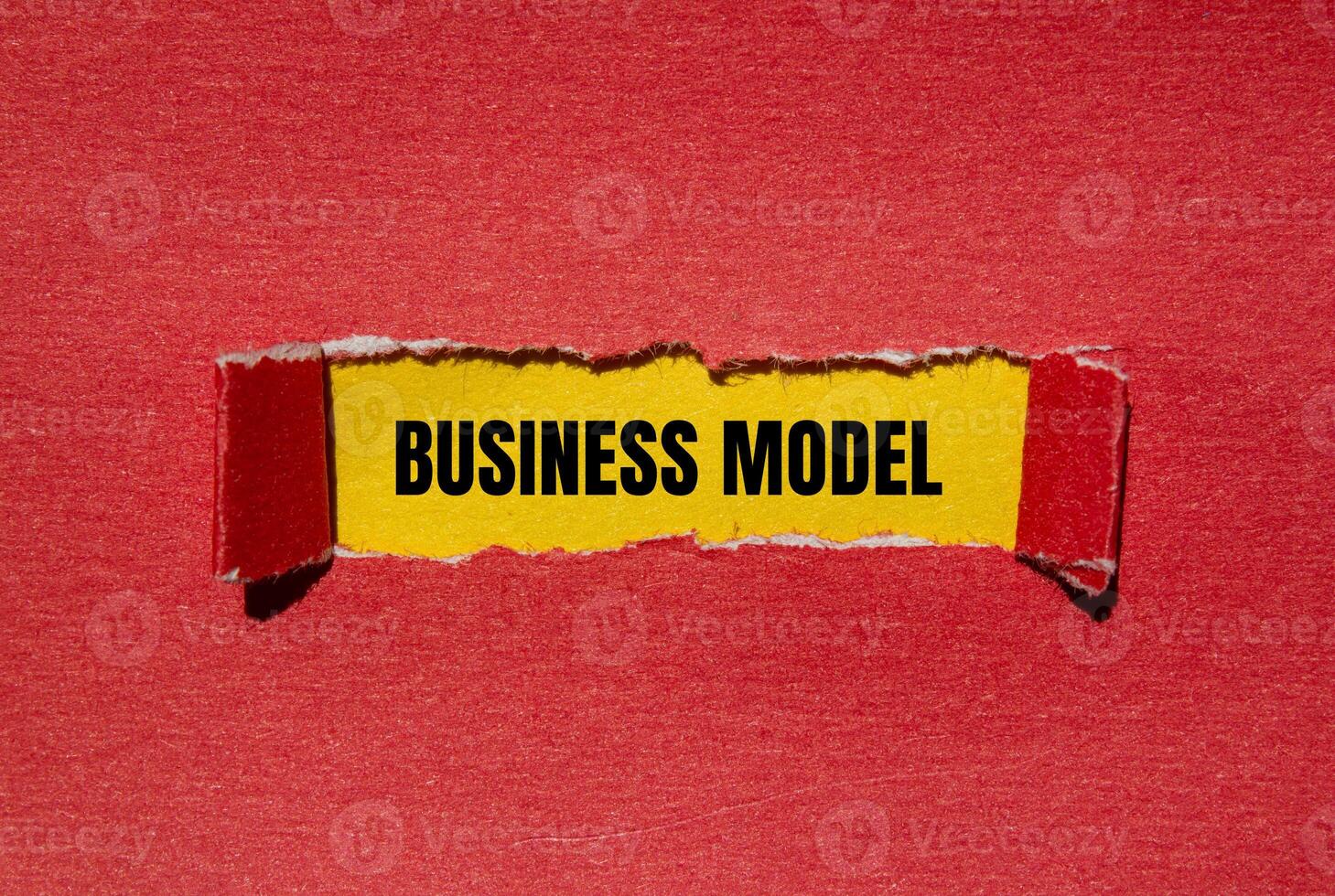 Business model message written on ripped torn red paper with yellow background. Conceptual business model symbol. Copy space. photo