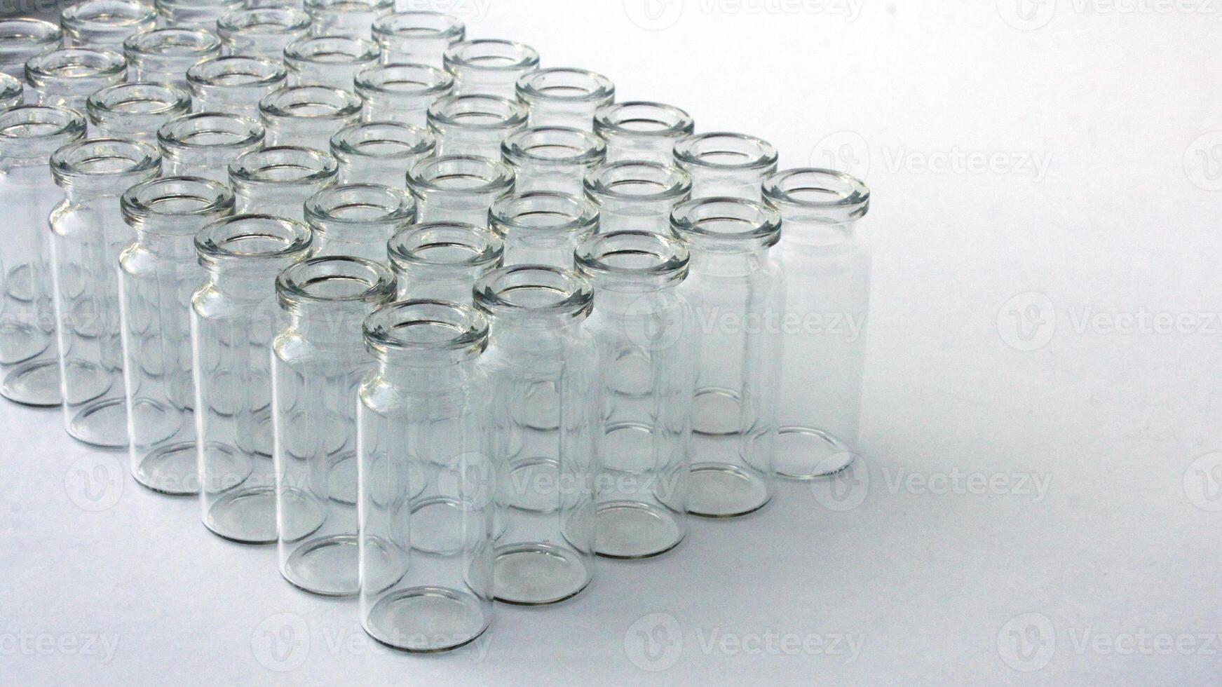 New glass vials for instrumental analysis on a white background. analytical vials prepared for chemical analysis photo