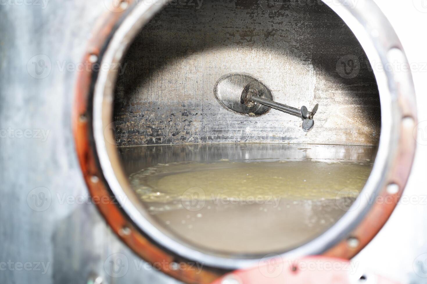 Vat with fermentation braga of the distillery. View of braga photo