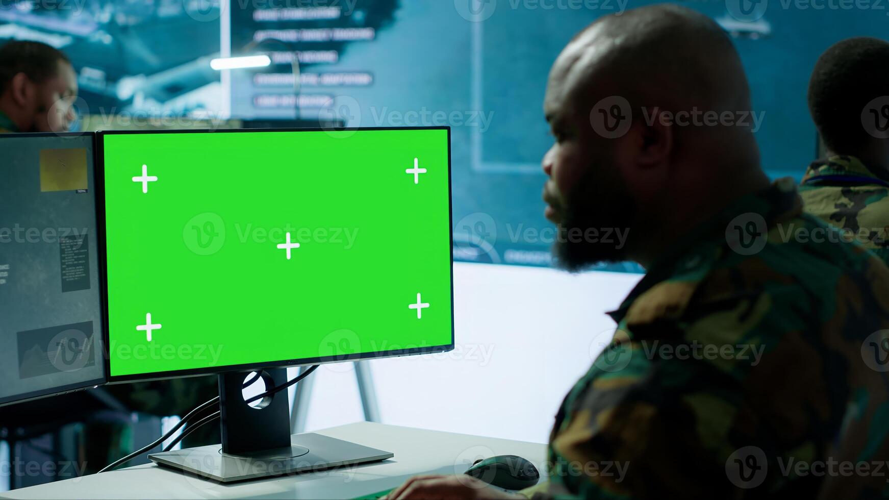 Army espionage specialist in a control center collecting satellite cctv data real time surveillance, strategic military operations. Working to ensure national security and protocols. Camera B. photo