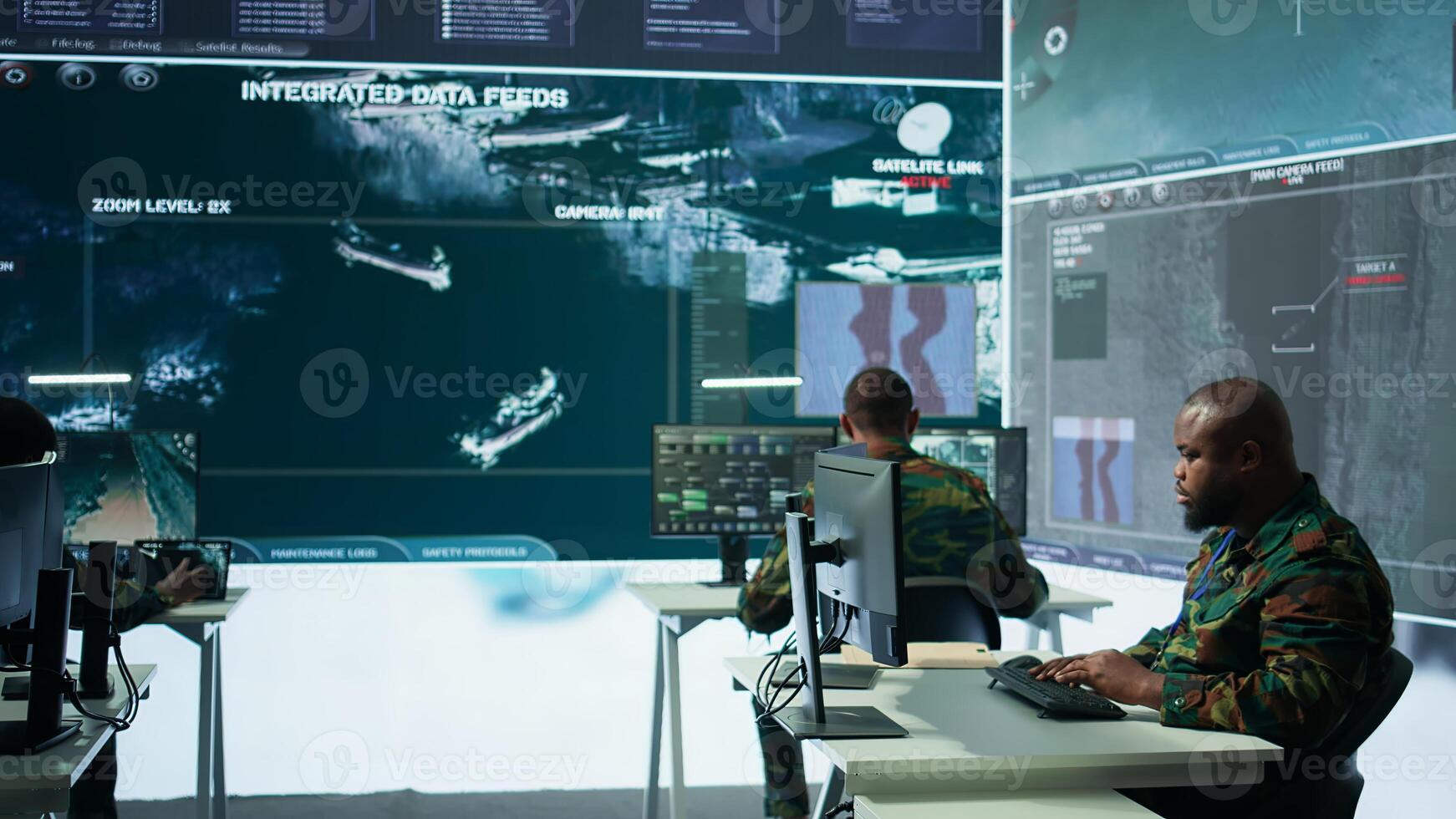 Military crew in a high tech operations command post managing information from radar cctv systems, real time data to support defense missions. Army protocols for national security. Camera B. photo