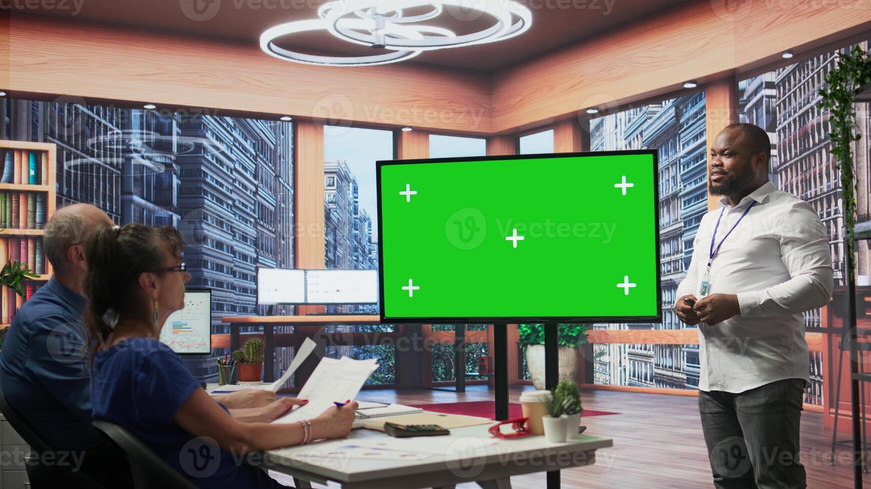 Elderly pair meeting with a financial broker next to copy space display, exploring retirement plan options and ensuring their pension for the future. Finances planning strategy. Camera B. photo