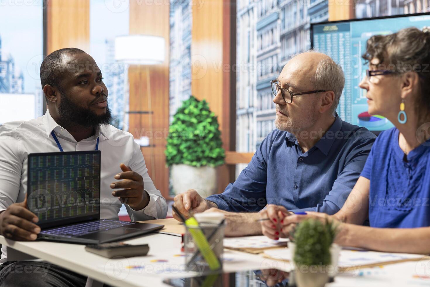 Financial planner exploring professional retirement plan options with old couple, presenting terms and policies to secure a pension for future stability. Helping clients manage savings. photo