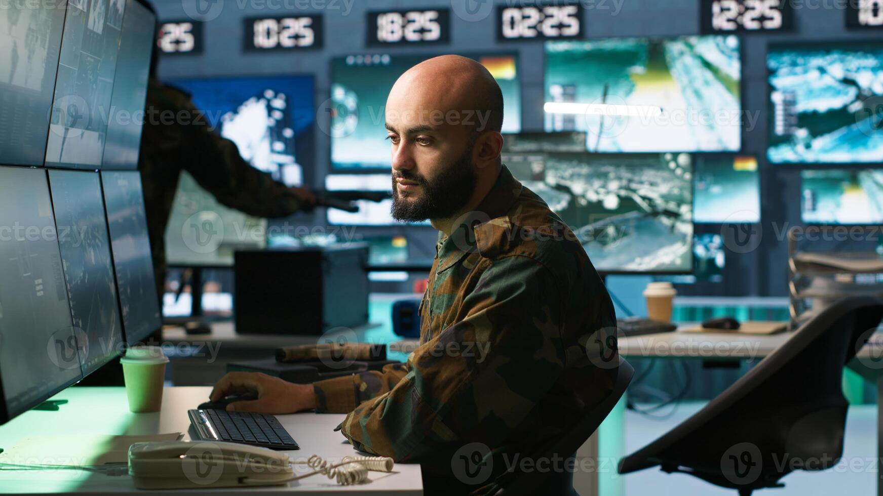 Man looking at screens in military HQ base housing operational missile defense system designed to intercept ballistic rockets. Special forces expert using tracking gear and radar systems, camera A photo