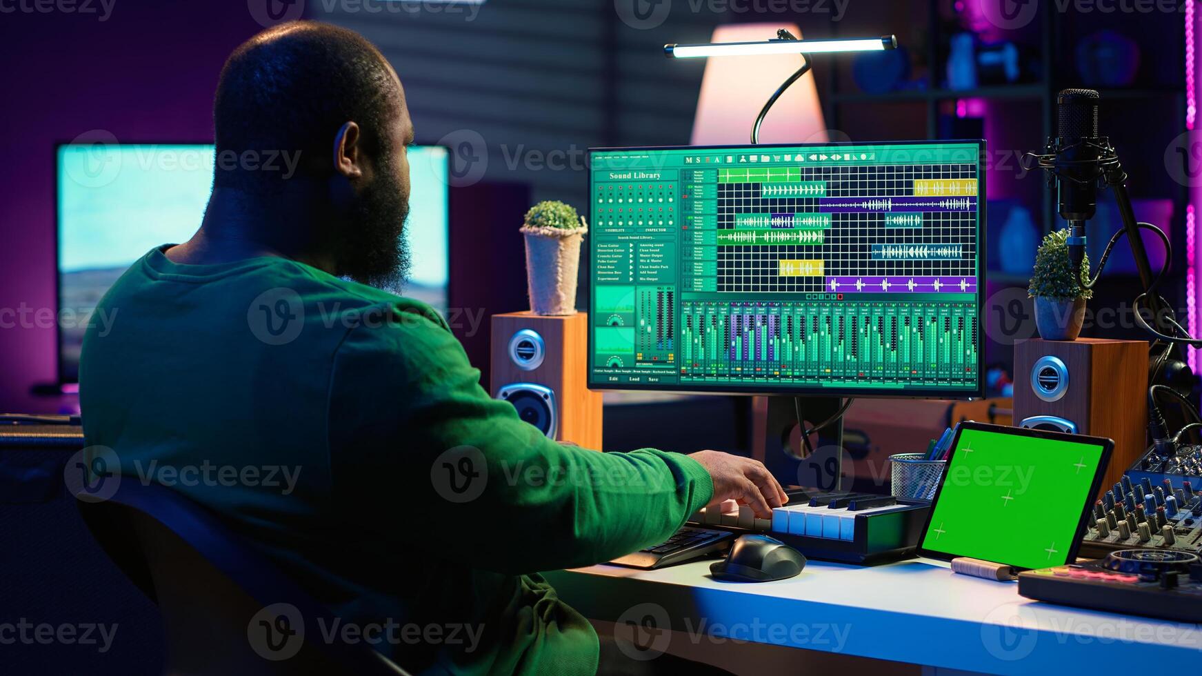 Artist producer creating new music with mix and master techniques, using a screen with copy space layout. Skilled audio engineer editing tracks in post production, digital audio software. Camera A. photo