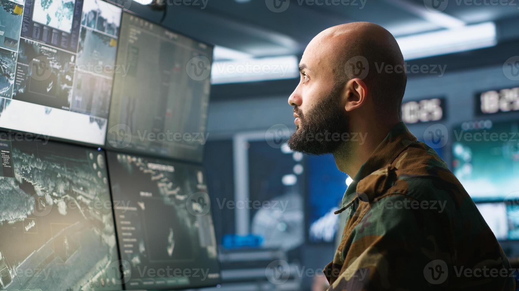 Soldier doing patriotic duty in military HQ base, gathering information on enemy troops. Officer using high tech monitoring gear to do assessment of enemy vulnerabilities, camera A photo
