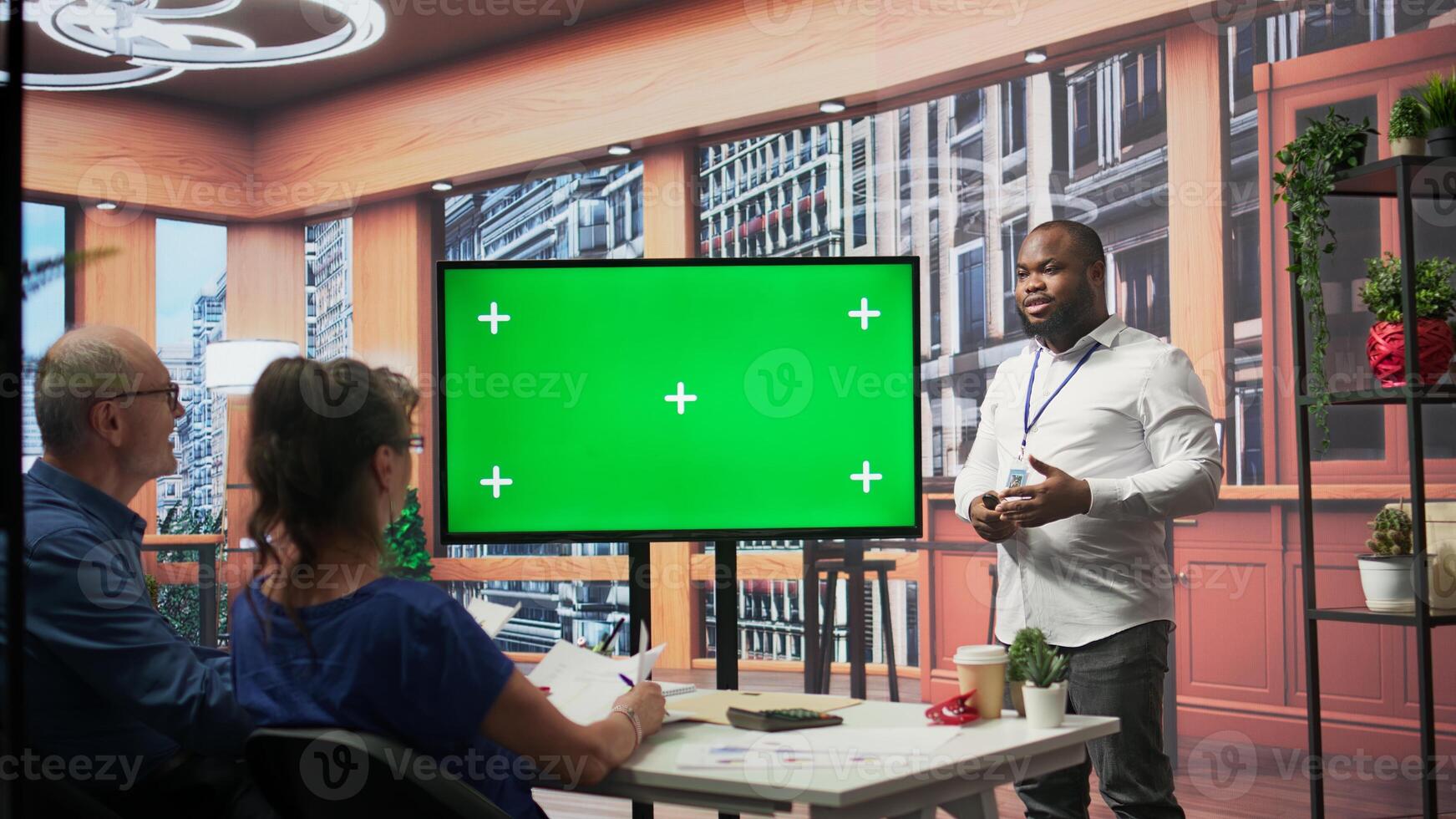Senior people meeting with a financial adviser about pension plans, using mockup copy space on laptop. Expert and clients exploring financial options for future investments. Camera B. photo