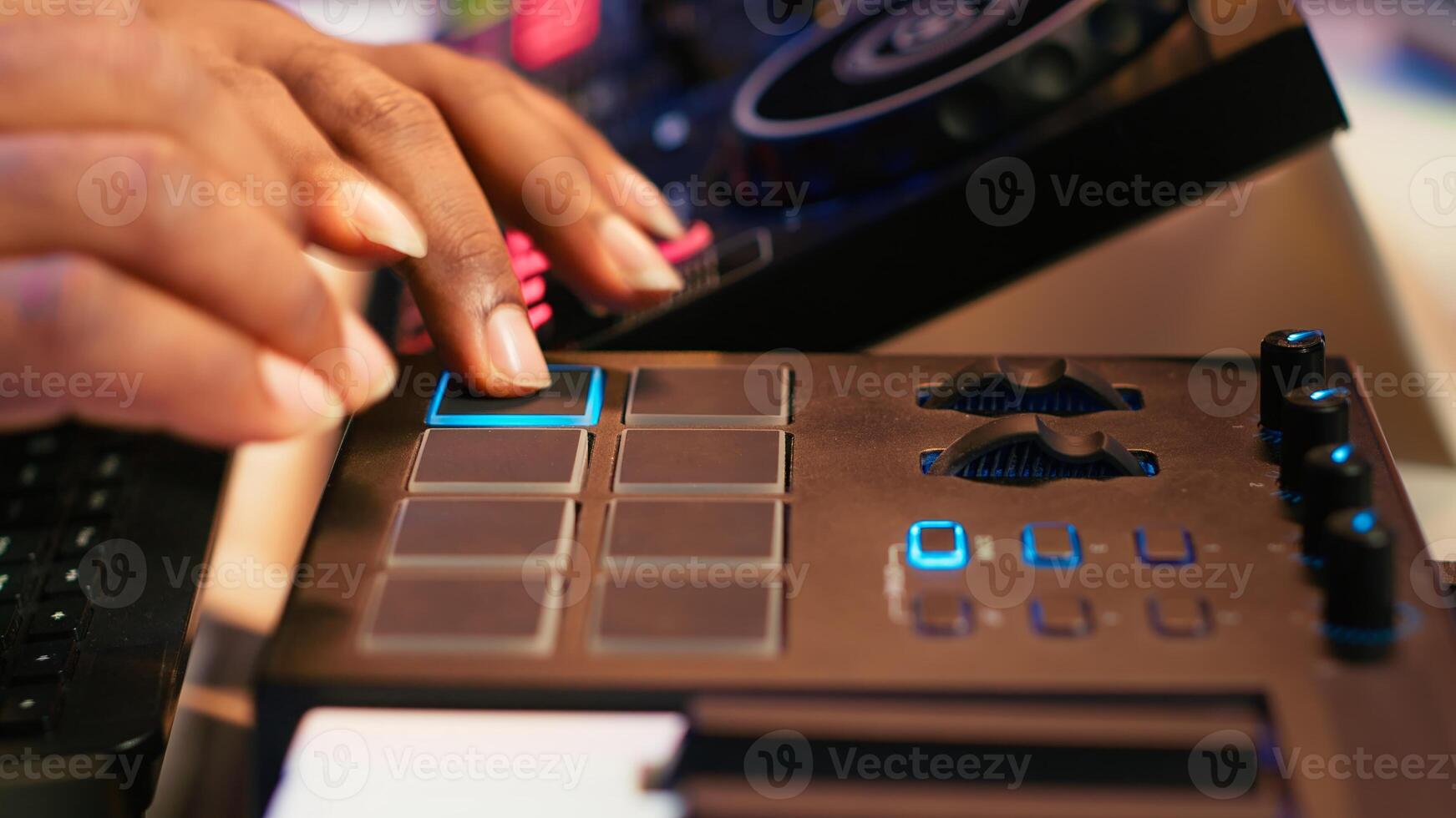 Audio engineer producing new music on mixing console in home studio, working with sound effects and pre amp knobs. Skilled producer creating songs and adjusting volume levels. Close up. Camera A. photo