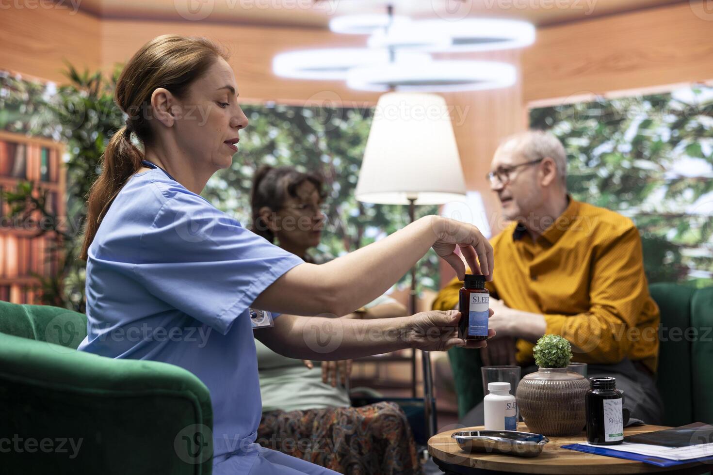 Social caregiver separating the medicaments and supplements pills, preparing daily doses for both senior people at home. Putting the capsules in two different bottles, healthcare medicine. photo
