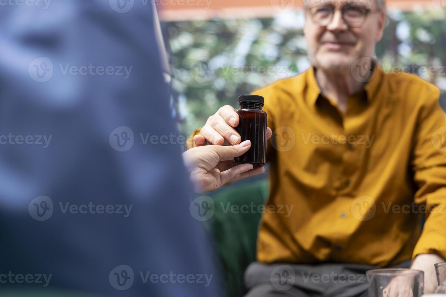 Social caretaker providing pills and medicine in different bottles for two patients, preparing the weekly treatment with daily doses for elderly man and woman. Nurse offer health aid. Close up. photo