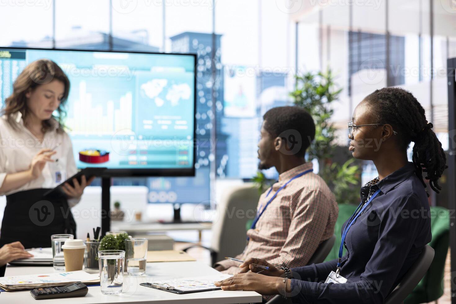 Coworkers engaging in a problem solving meeting at a corporation, using an interactive board to visualize data and develop solutions for complex business challenges. Analysis presentation. photo